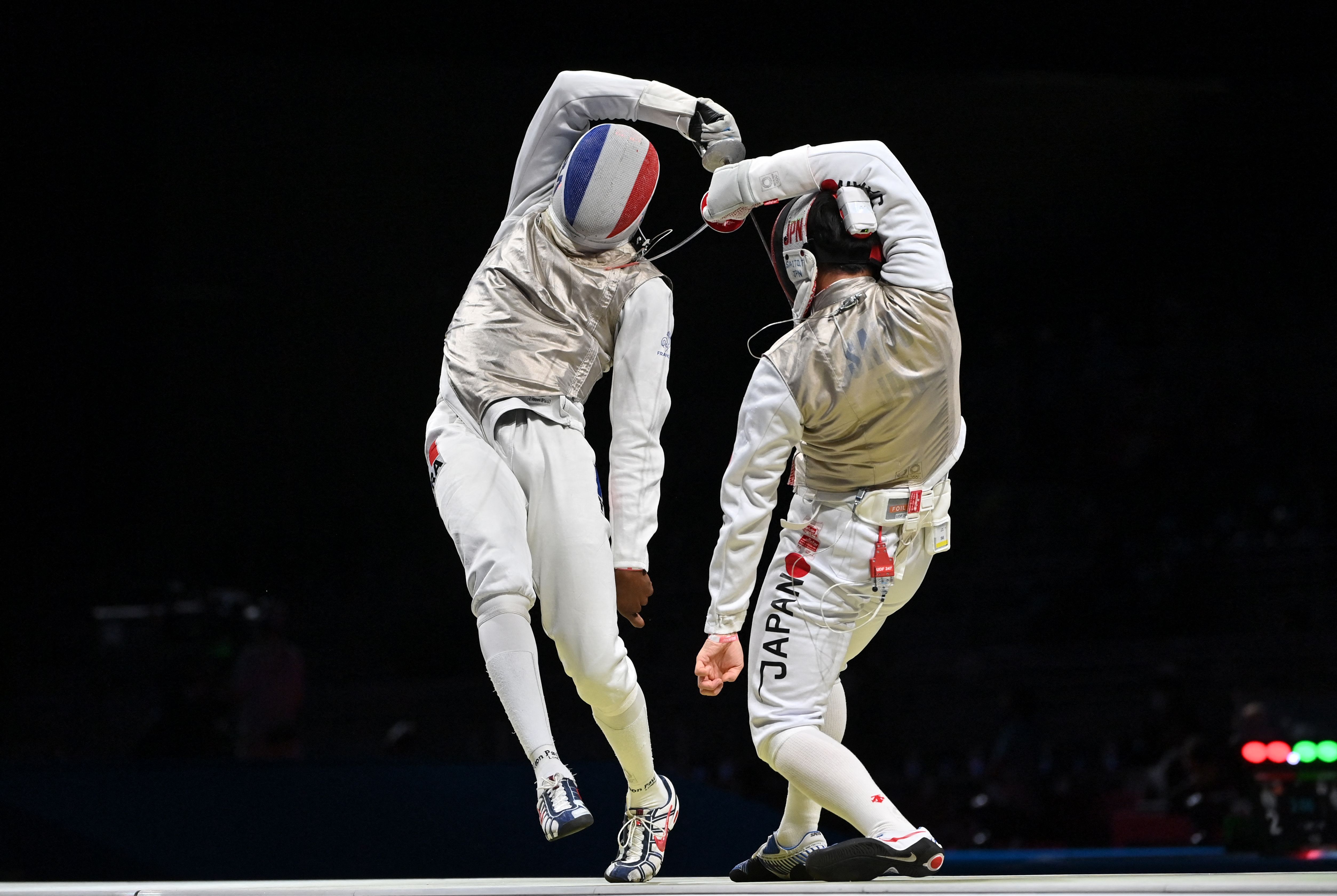 France's Enzo Lefort (L) compete against Japan's Toshiya Saito in the mens individual foil qualifying bout during the Tokyo 2020 Olympic Games 