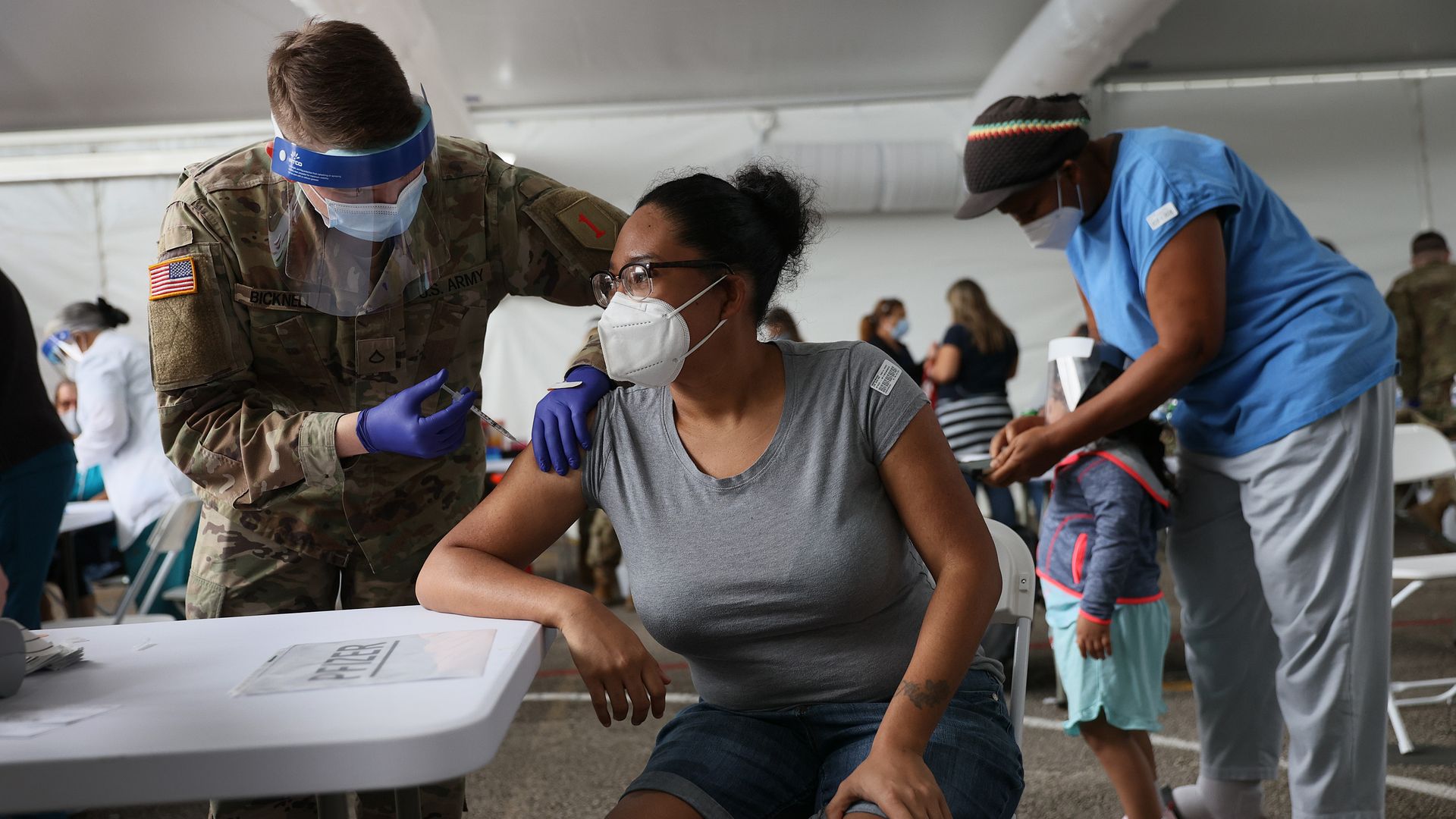 A soldier administers a coronavirus vaccine in Miami. 