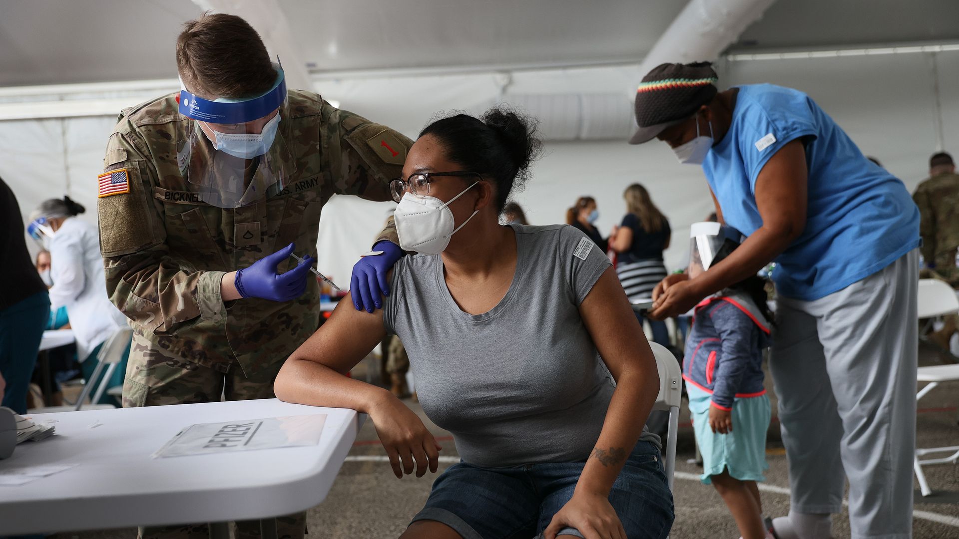 A soldier administers a coronavirus vaccine in Miami.