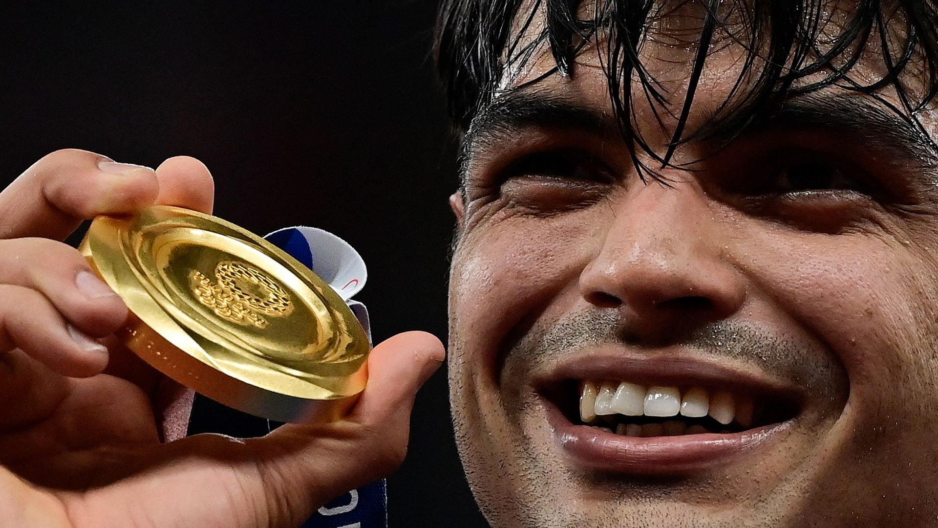 Gold medallist India's Neeraj Chopra celebrates on the podium during the victory ceremony for the men's javelin throw event during the Tokyo 2020 Olympic Game