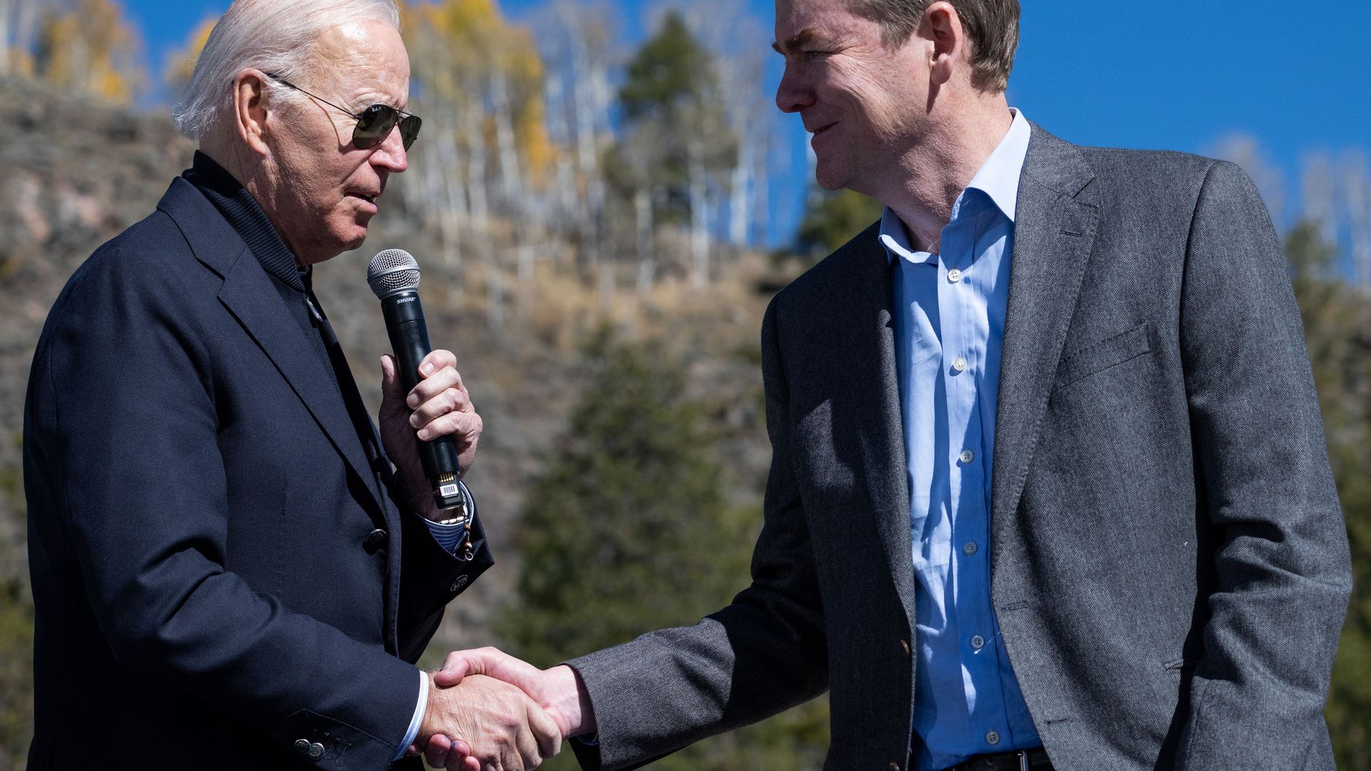 President Biden shakes hands with U.S. Senator Michael Bennet at Camp Hale near Leadville on Oct. 12. Photo: Saul Loeb/AFP via Getty Images