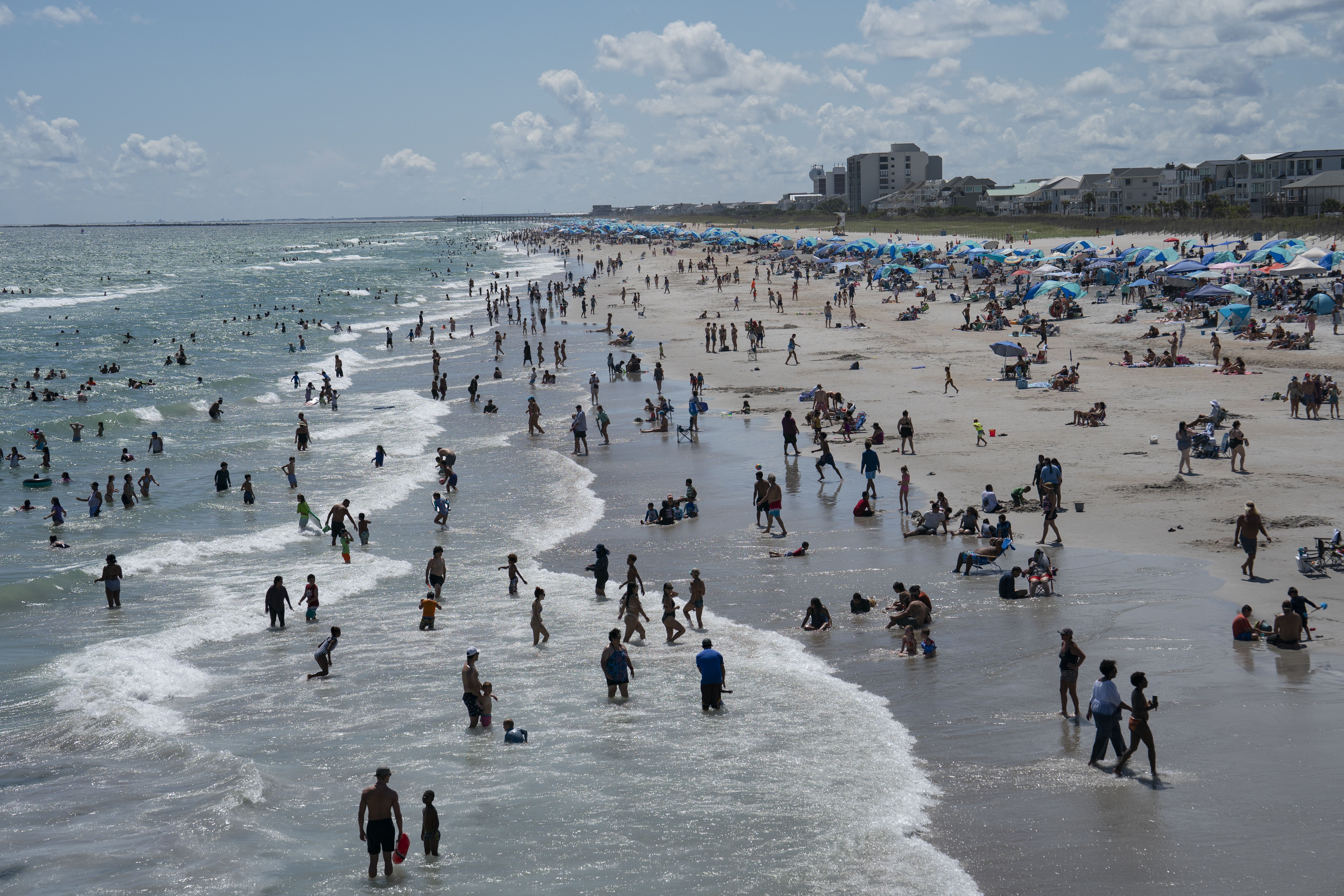 WRIGHTSVILLE BEACH, NORTH CAROLINA - SEPTEMBER 01: People are seen on the beach on September 1, 2024 in Wrightsville Beach, North Carolina. Airports, highways, beaches and theme parks are expected to be packed across the U.S. this Labor Day in what the TSA expects to be the busiest on record. (Photo