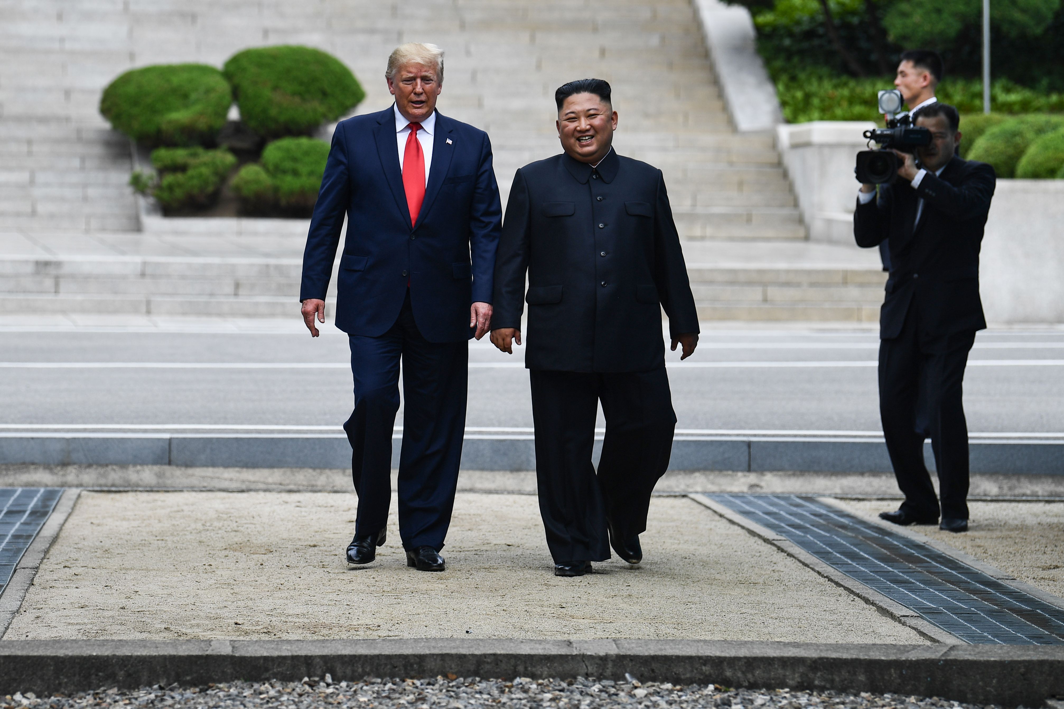 North Korea's leader Kim Jong Un walks with US President Donald Trump in the Joint Security Area (JSA) of Panmunjom in the DMZ.