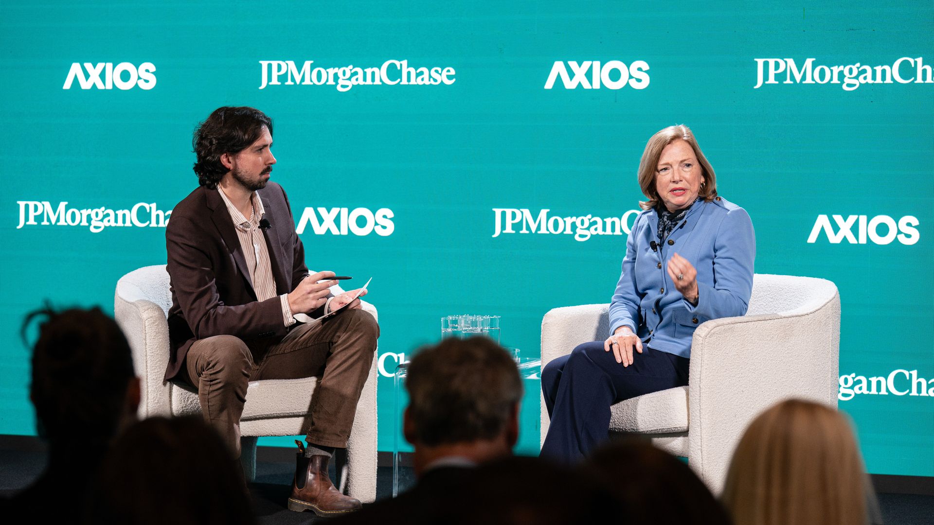 USA Rare Earth CEO Barbara Humpton wears a blue jacket and gestures while speaking with Axios' Colin Demarest.