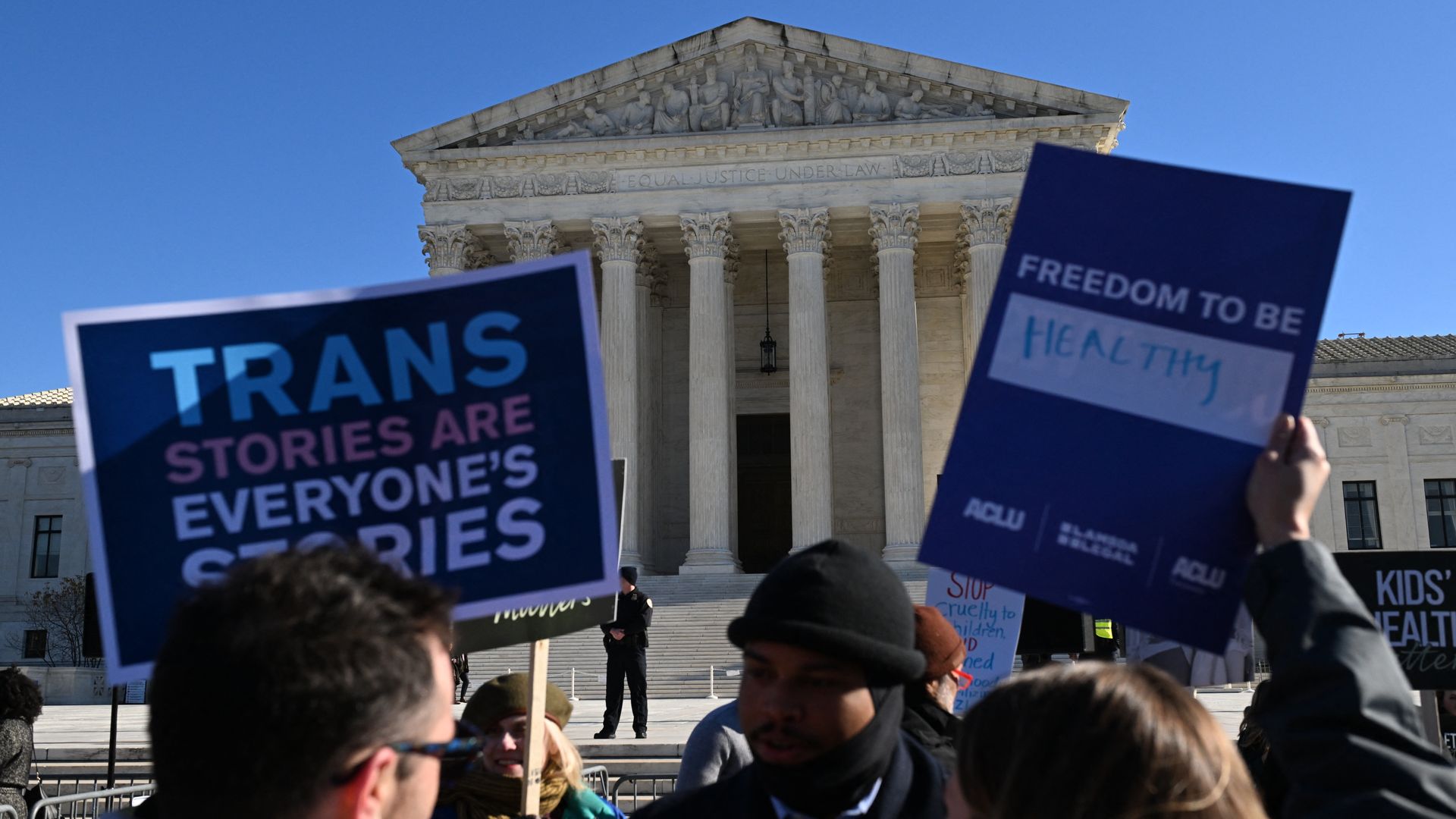 People hold signs outside the US Supreme Court on December 4, 2024 in Washington, DC, during oral argument on whether states can ban certain gender transition medical treatments for young people. The case was brought by three transgender teens, their parents and a doctor who are seeking to ensure he