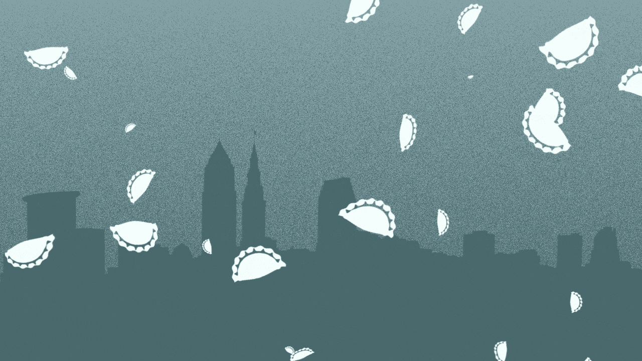 Animated illustration of the Cleveland skyline with snowflakes in the shape of pierogis falling on it.