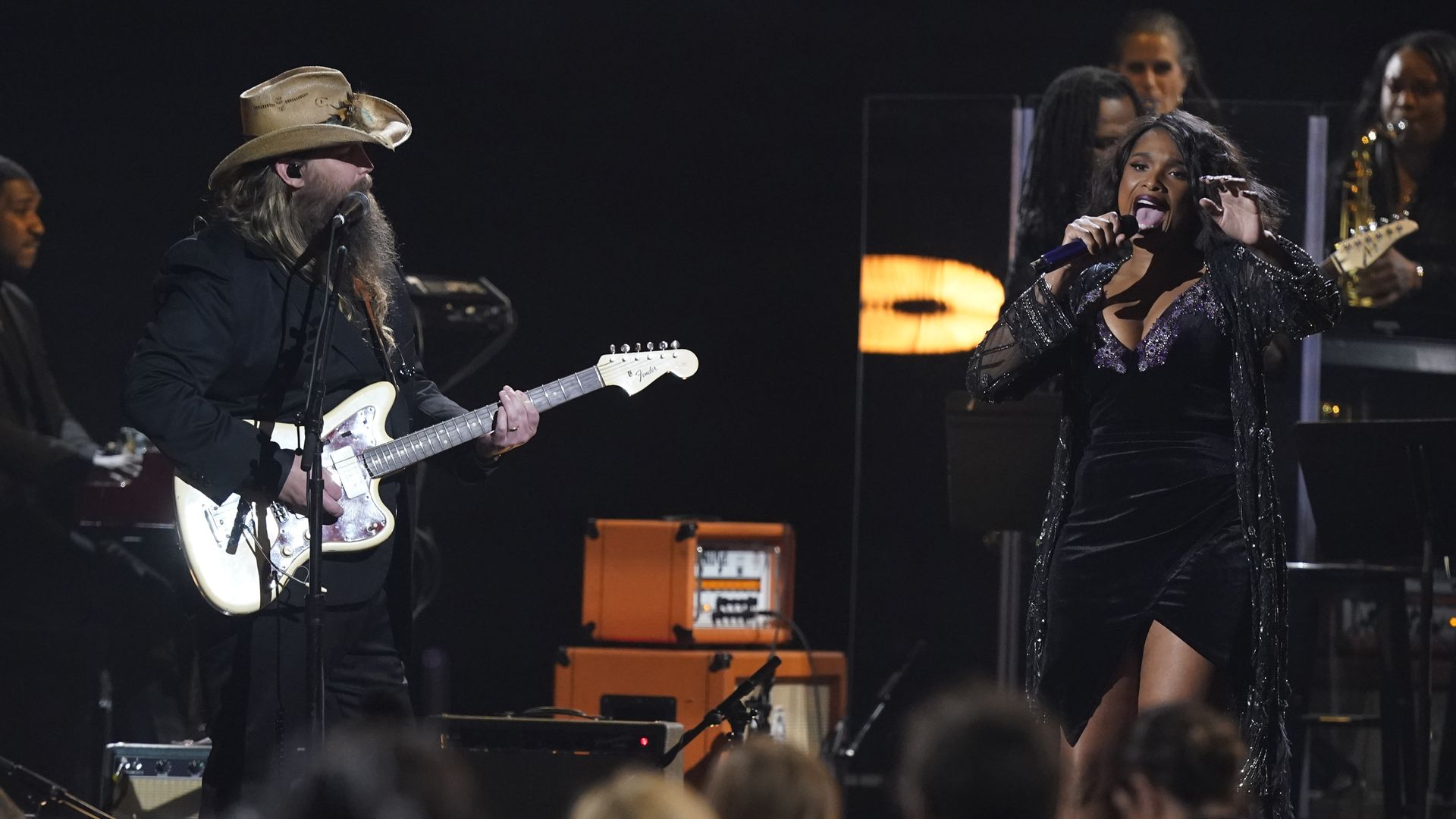 Chris Stapleton and Jennifer Hudson on stage singing a duet.