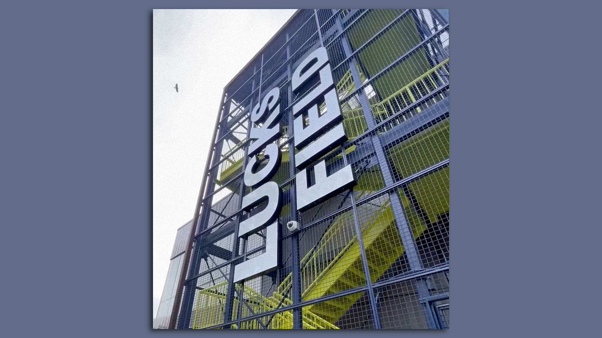 A metal yellow and grey stair case that says Lucks Field 