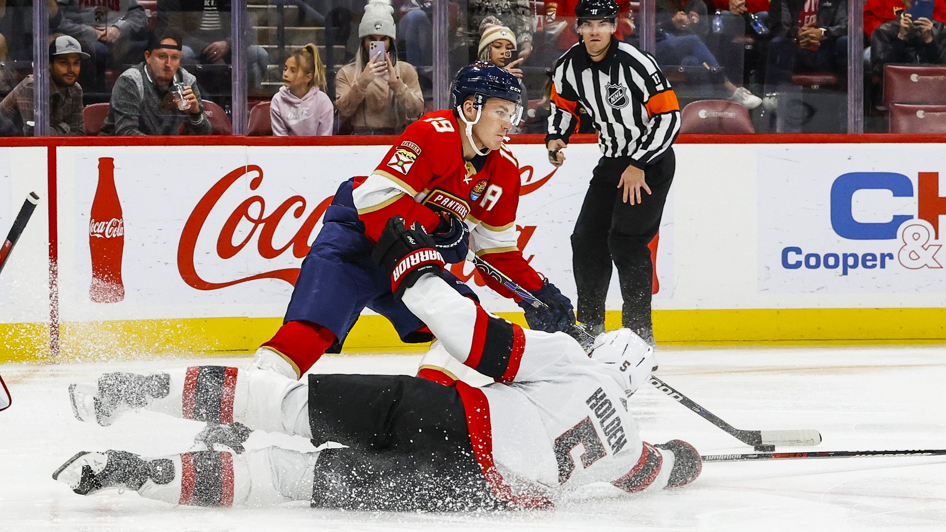 Ottowa Senators player Nick Holden drops down to defend Florida Panthers player Matthew Tkachuk.