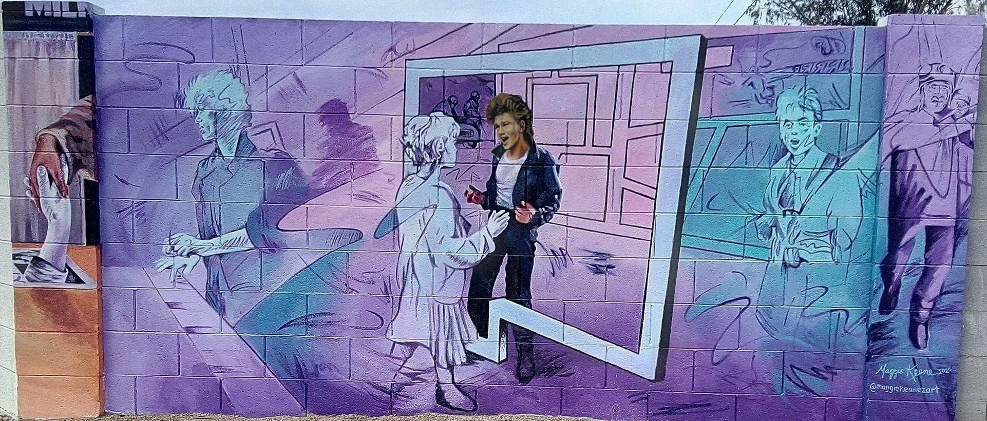 A mural on a cinder block wall depicting a scene from A-Ha's music video for the song "Take On Me".