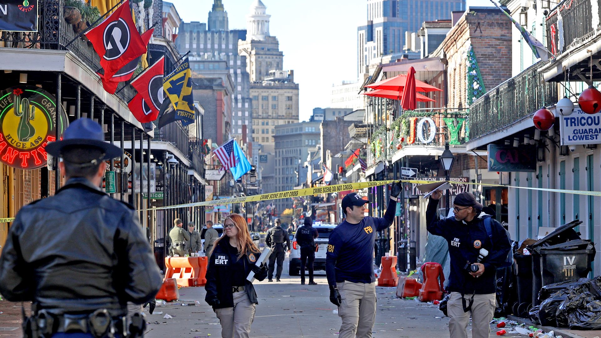 Law enforcement officers from multiple agencies work the scene on Bourbon Street after a deadly attack.