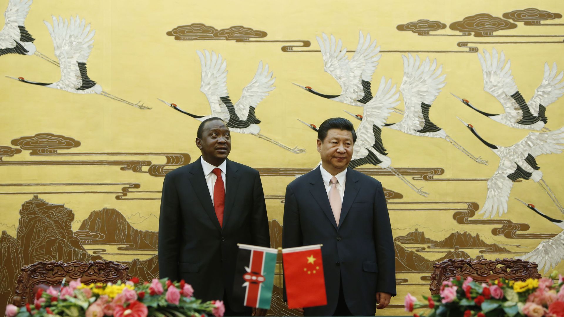 Xi and Uhuru stand in front of a mural of birds in Beijing's Great Hall of the People