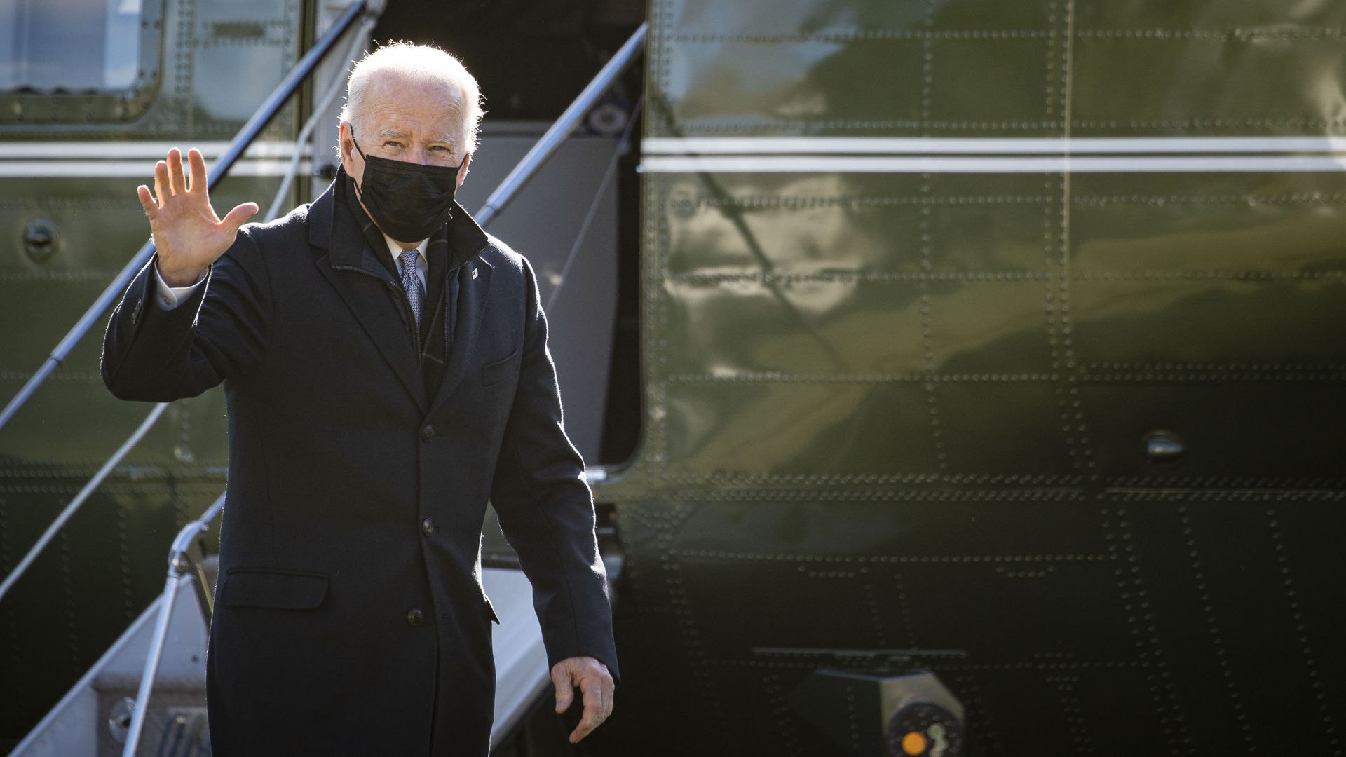 President Joe Biden waves while walking on the South Lawn of the White House after arriving on Marine One.