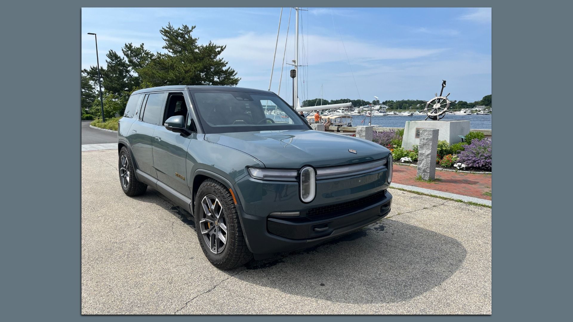 Image of a gray Rivian R1S SUV parked near the harbor in Newburyport, Mass. 