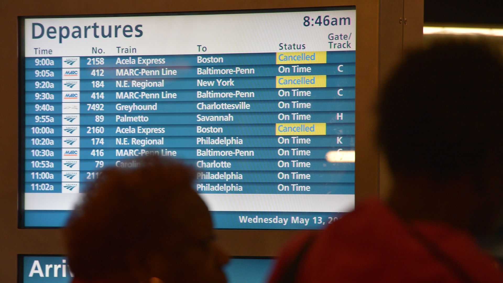 Women line up for the ticketing counters next to a monitor displaying cancelled trains at Union Station on May 13, 2015 in Washington, DC. A New York bound Amtrak train heading from Washington, DC derailed in Phildelphia late May 12, killing 6 people. AFP PHOTO/MANDEL NGAN (Photo credit should read 