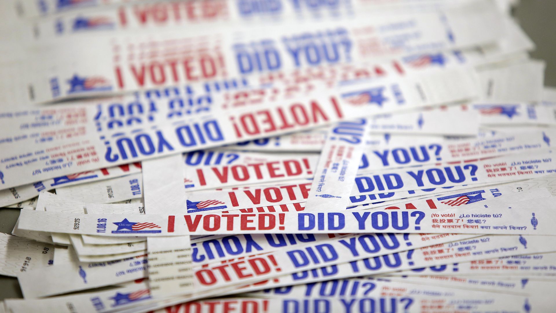 Stickers reading "I voted" in red and blue in a stack