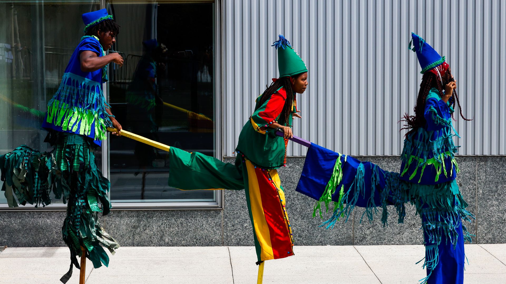 Photo of three circus performers on stilts