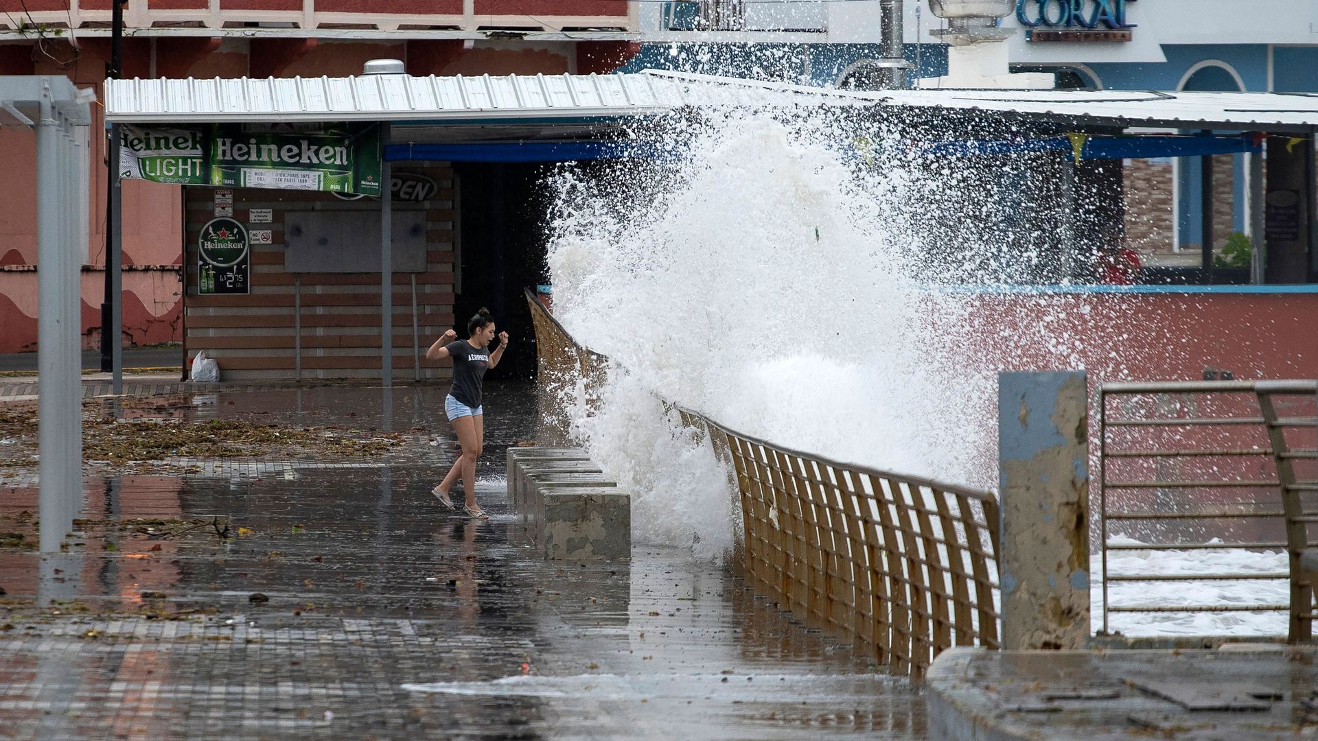  A woman walks next to the coast as tropical Storm Karen approaches in Naguabo, Puerto Rico, on September 24