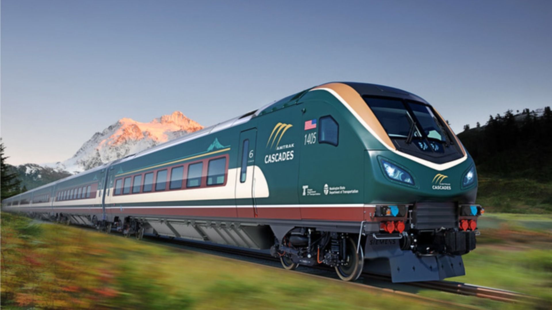 A sleek green and cream train pictured in front of Mt. Rainier. 