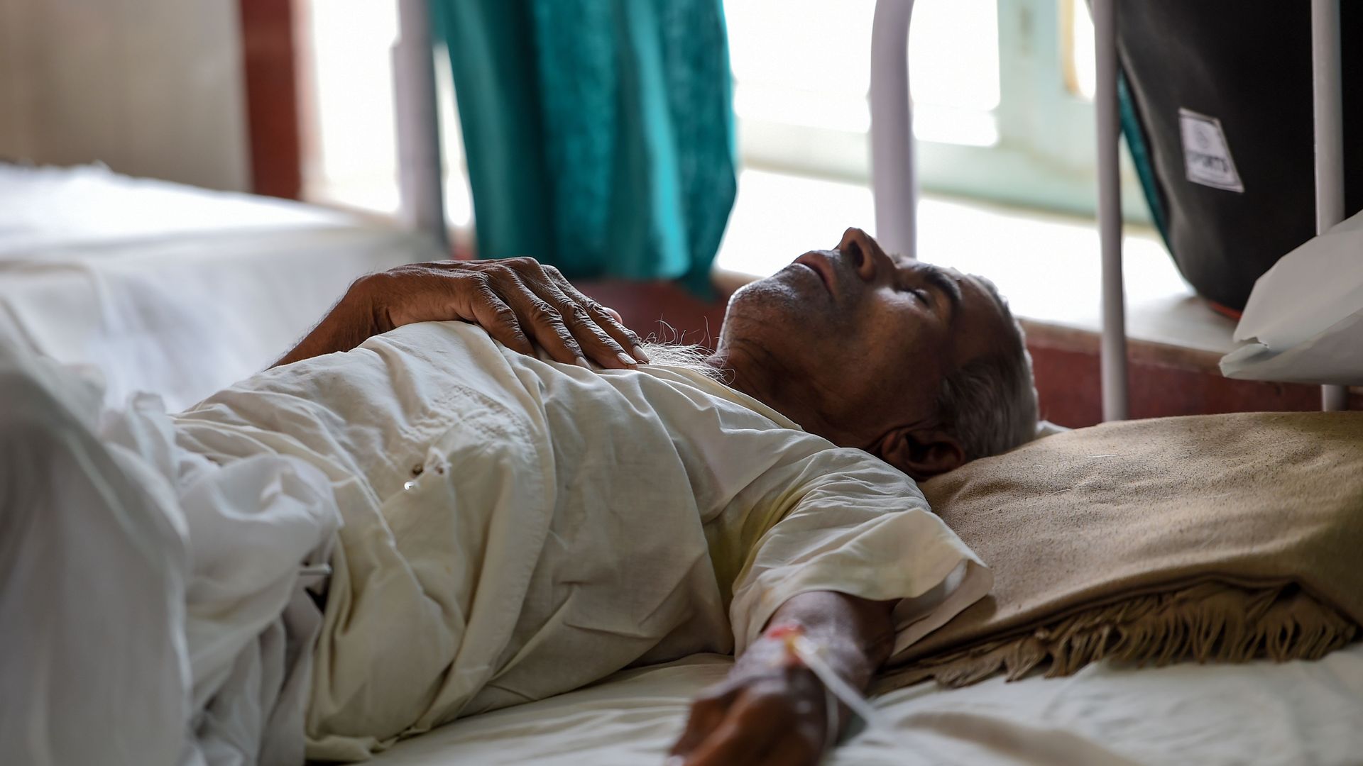 An Indian patient lies on a bed at a government hospital after suffering heat stroke in 2019.