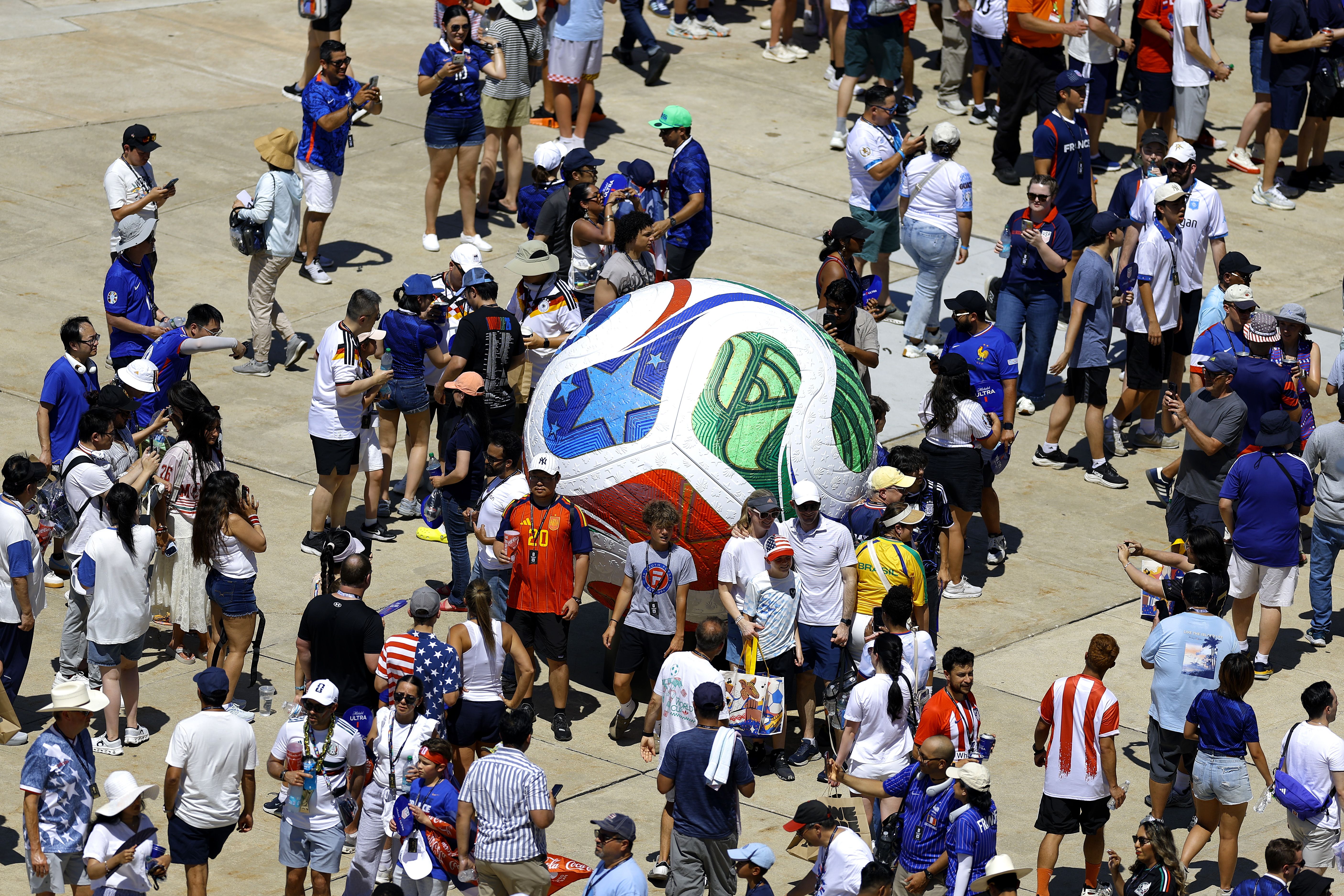 Fans gathered around a giant soccer ball outside Philadelphia Stadium during Philly's knockout match between Paraguay and France.