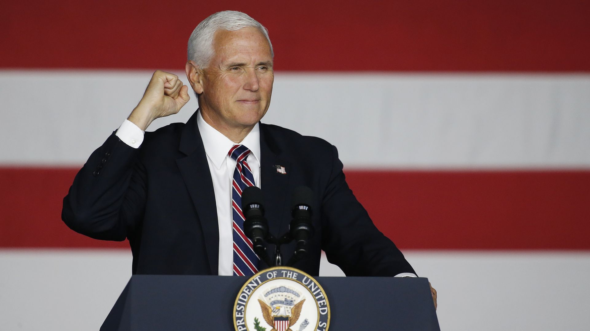 Pence stands behind a podium 