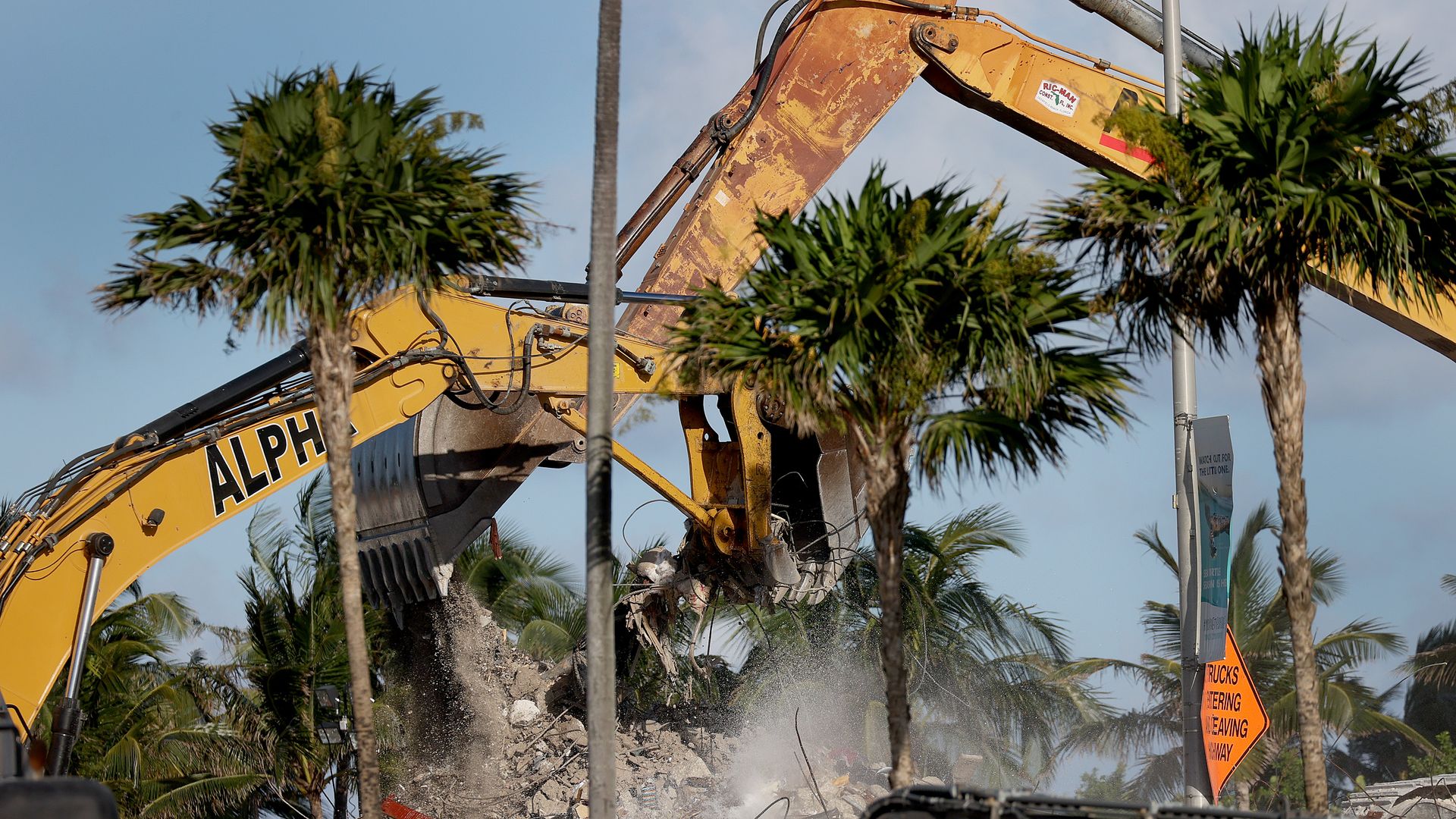 Excavating machinery continues to dig through the ruins of the partially collapsed 12-story Champlain Towers South condo building in Surfside, Florida.