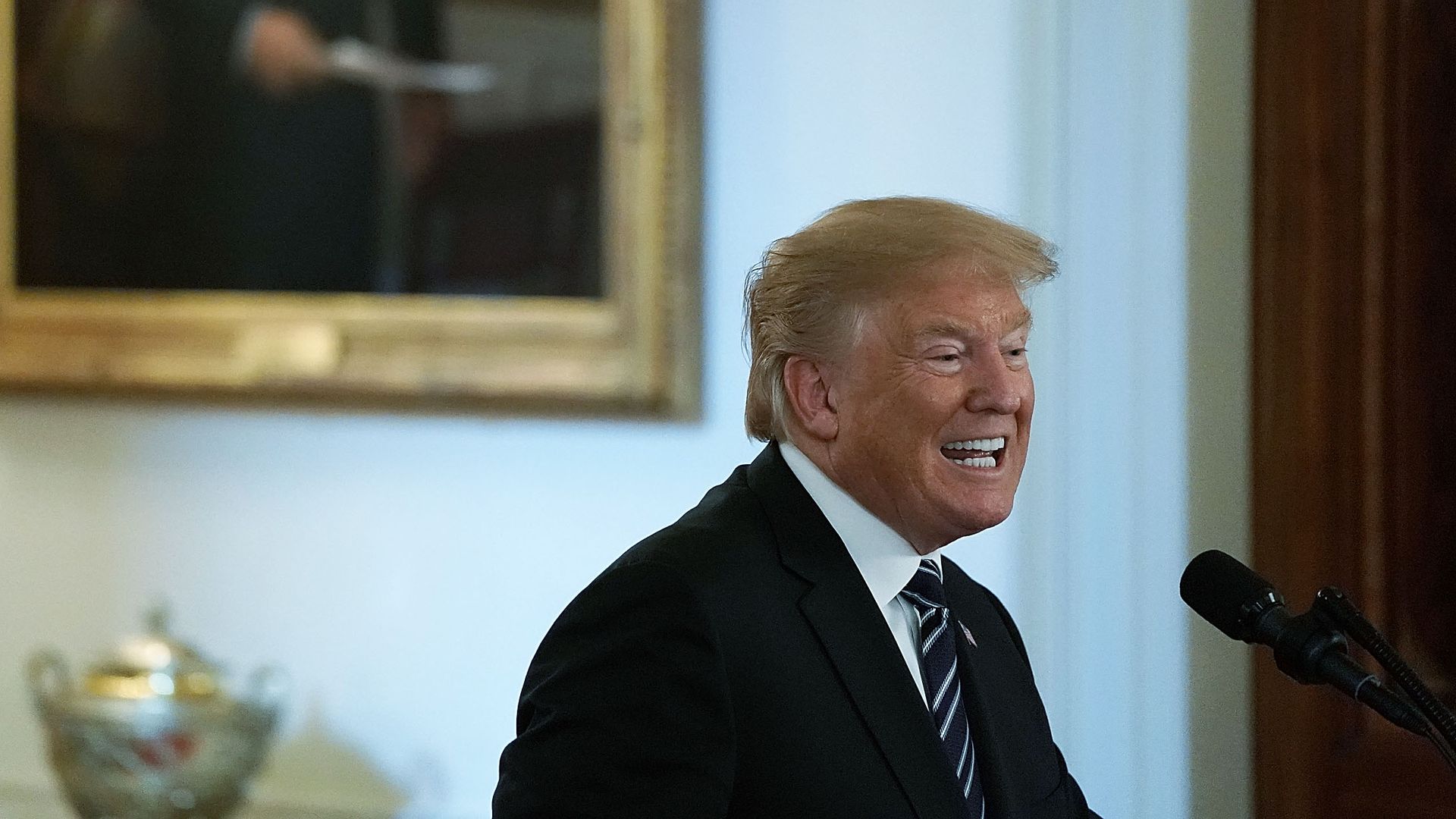 Donald Trump speaking into a podium