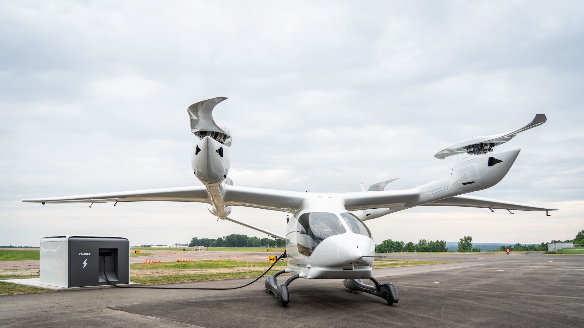 Photo of a Beta Technologies ALIA eVTOL aircraft charging from one of its units. 