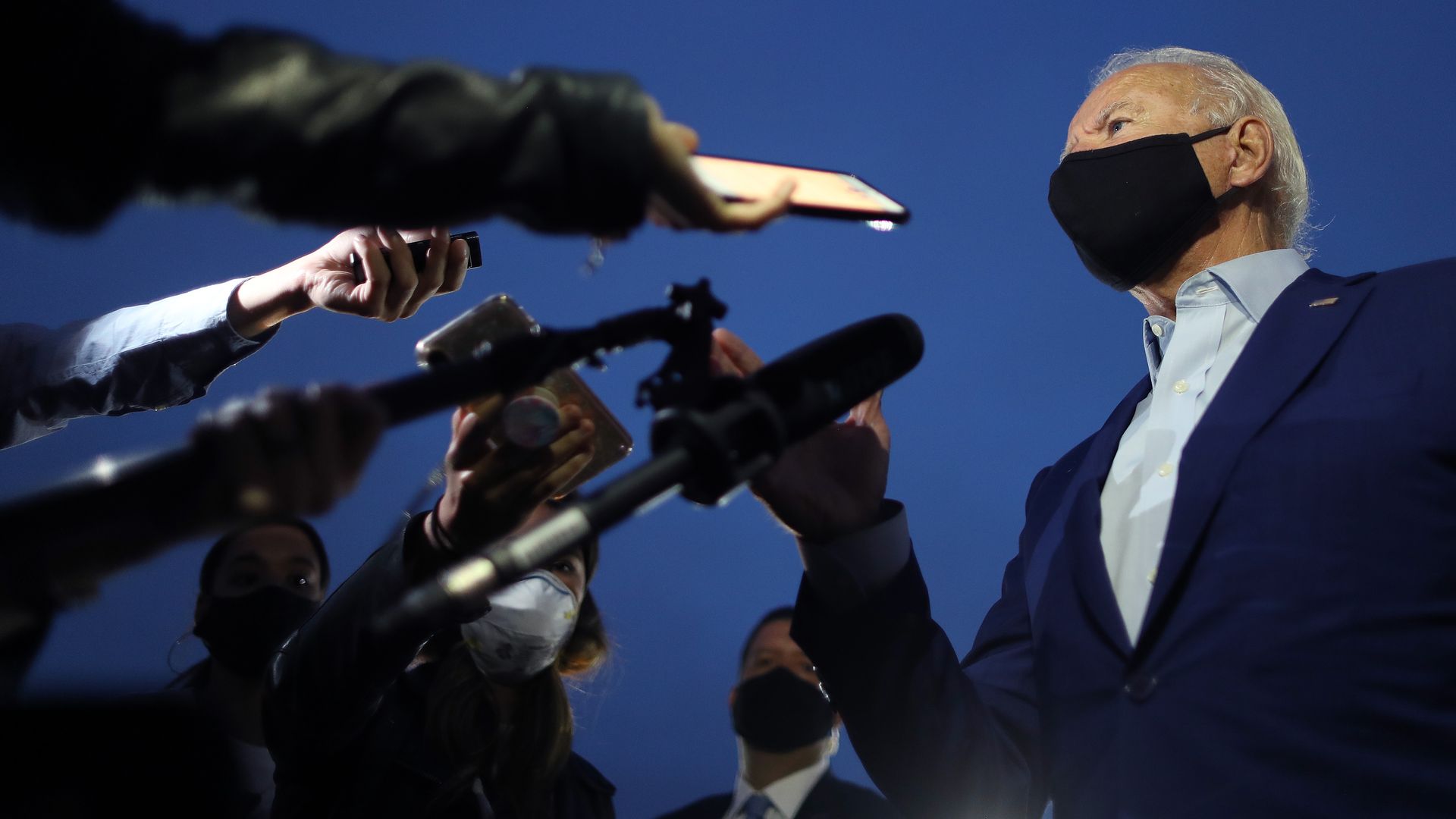 Biden wears a face mask while talking to the press