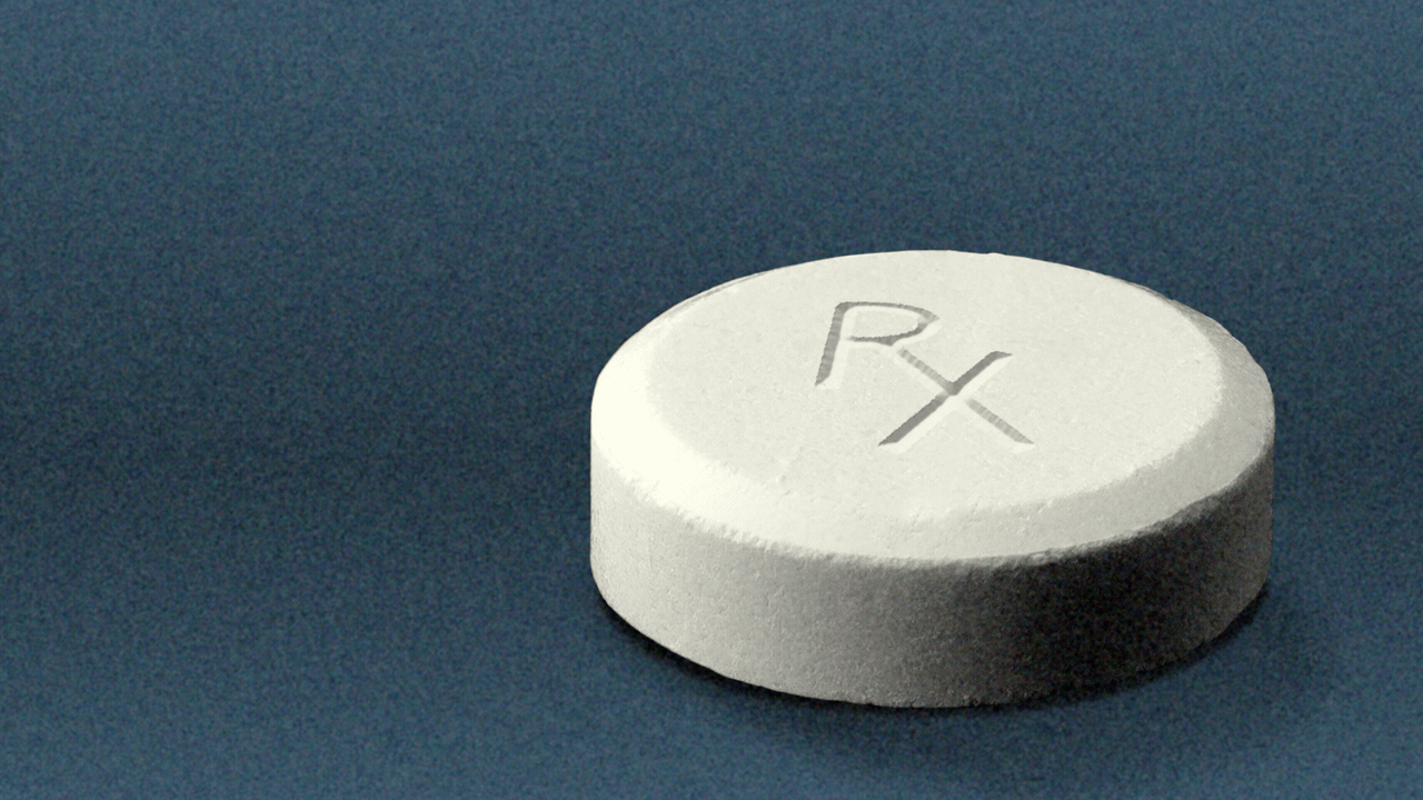Animated illustration of a pill with an Rx prescription symbol embossed onto it that changes into a percent sign.
