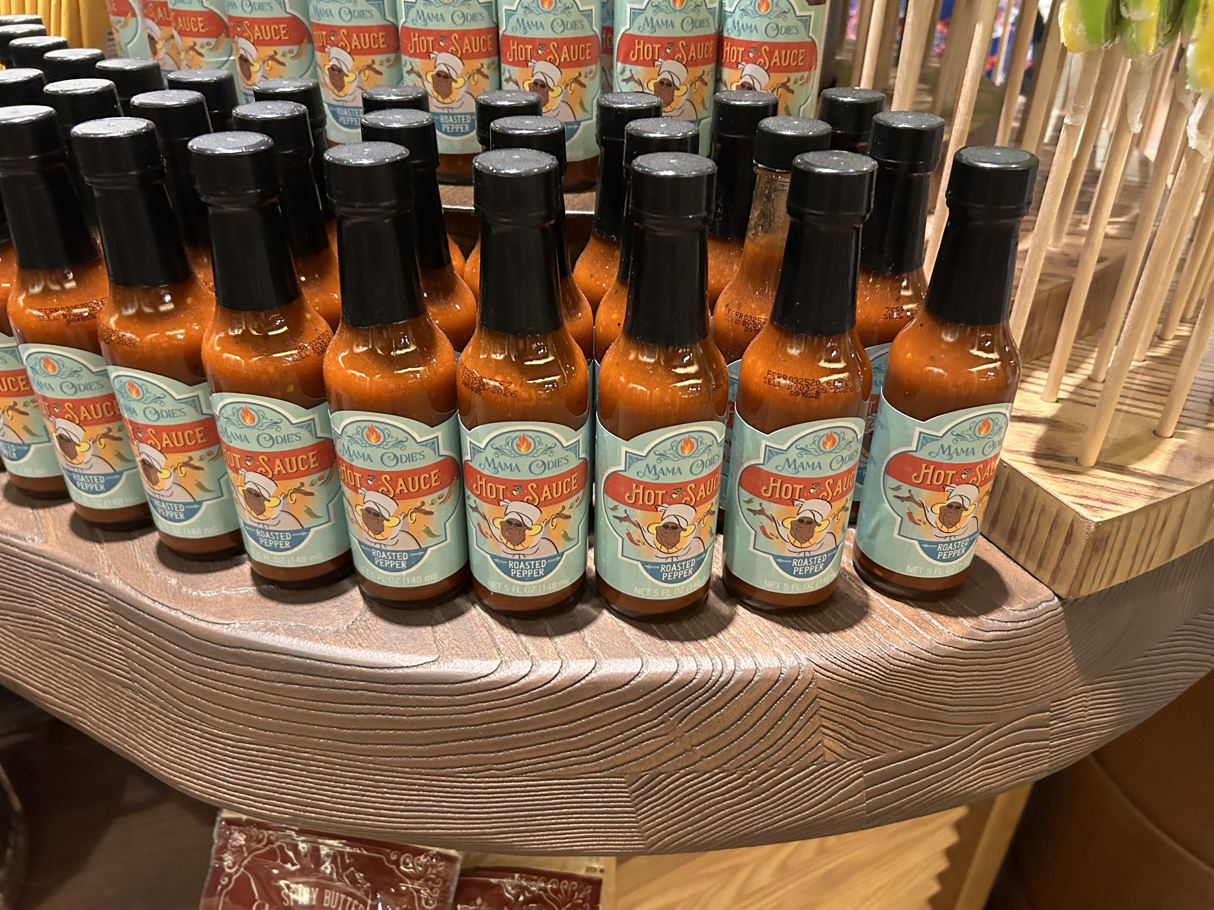 Hot sauce bottles on a shelf.