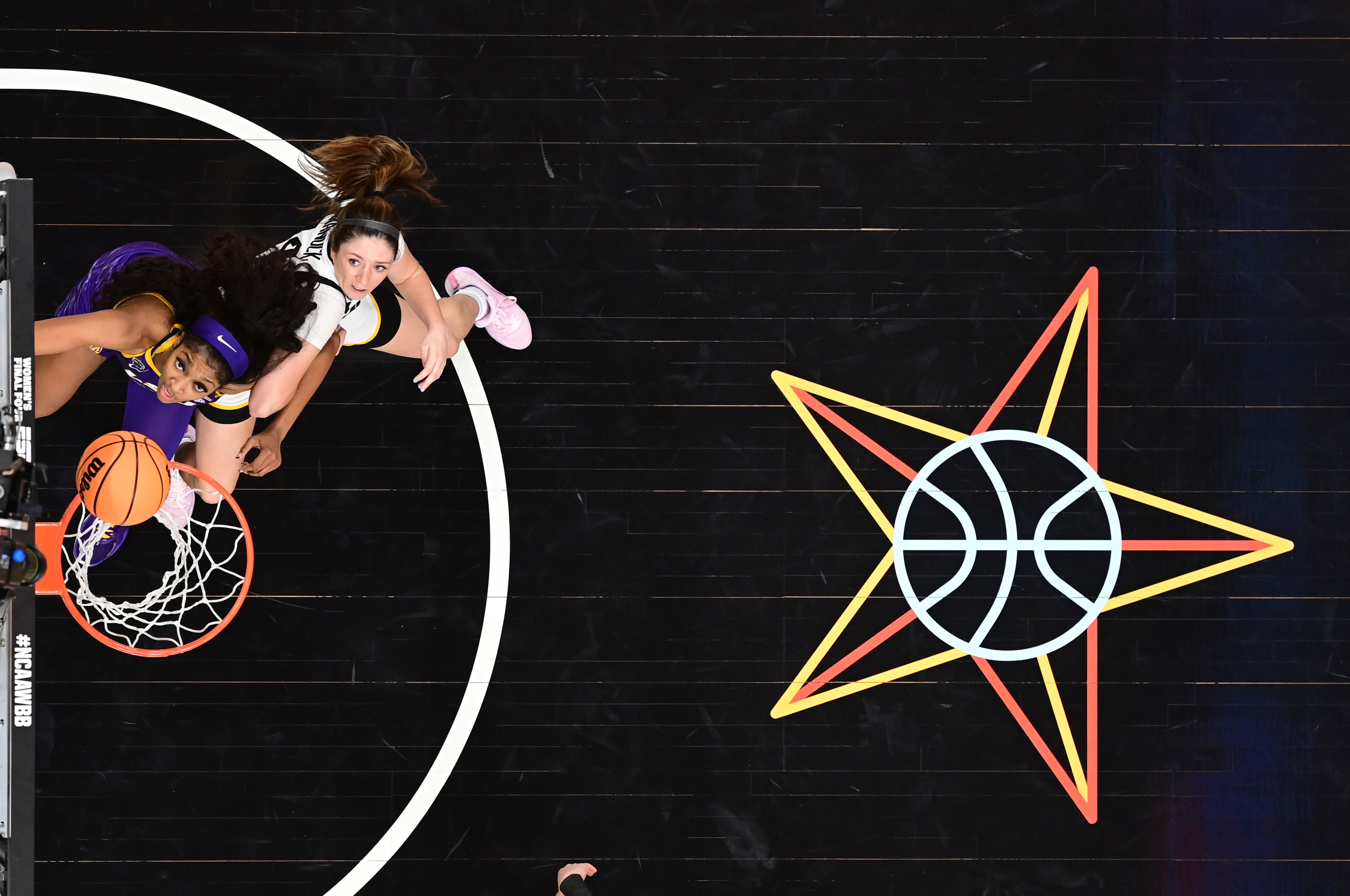 McKenna Warnock #14 of the Iowa Hawkeyes and Angel Reese #10 of the LSU Lady Tigers look to the ball on the rim during the 2023 NCAA Women's Basketball Tournament National Championship at American Airlines Center on April 2, 2023 in Dallas, Texas.