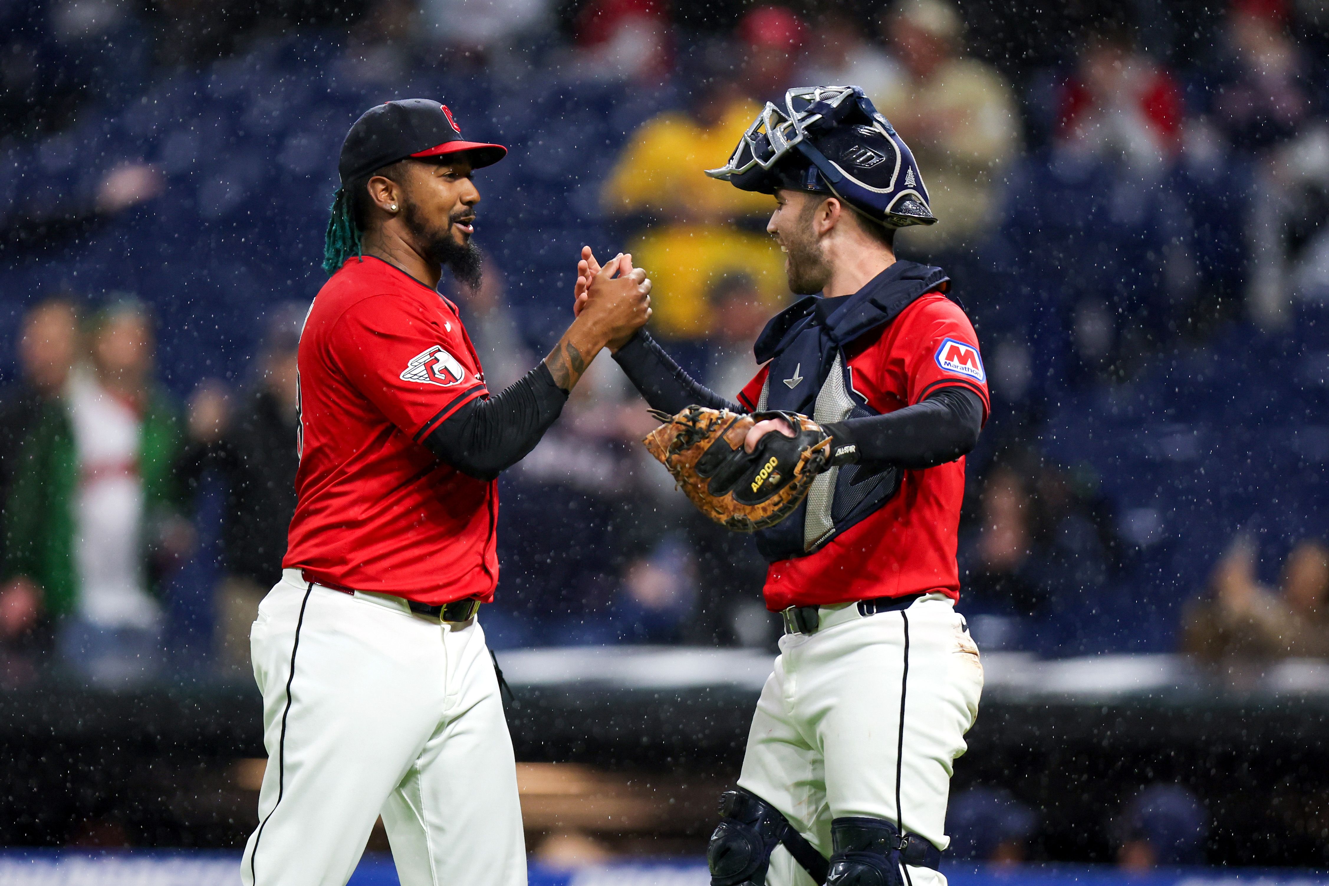 Emmanuel Clase and David Fry shake hands on the baseball field.