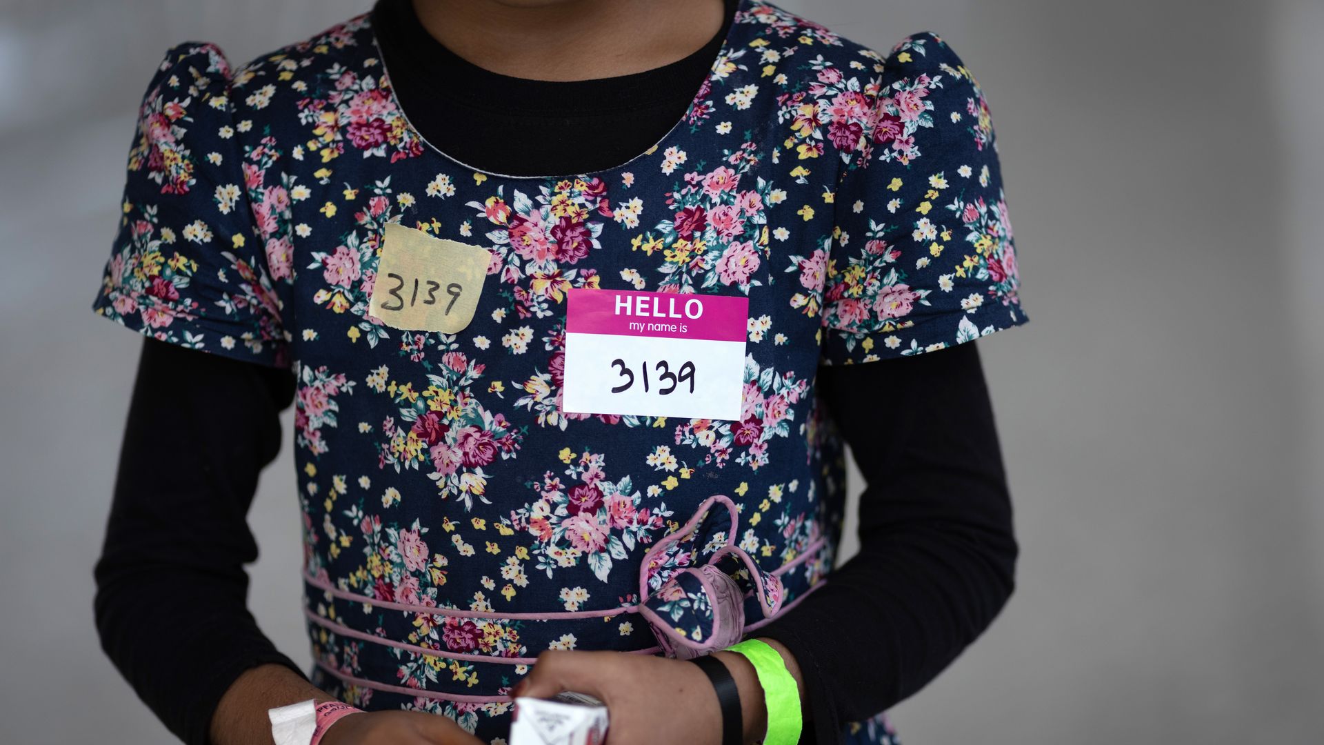 A girl in a dress with a name tag.