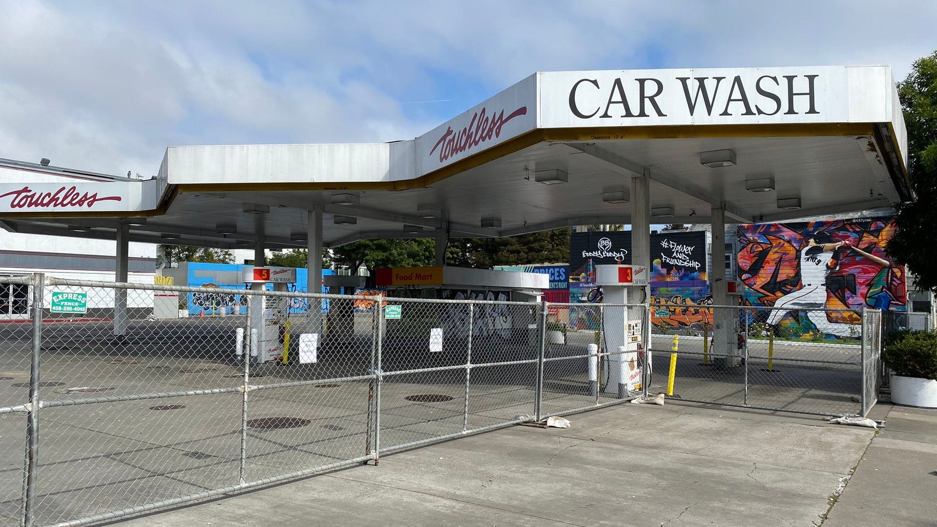 Former car wash near Divisadero street with fence around it. 