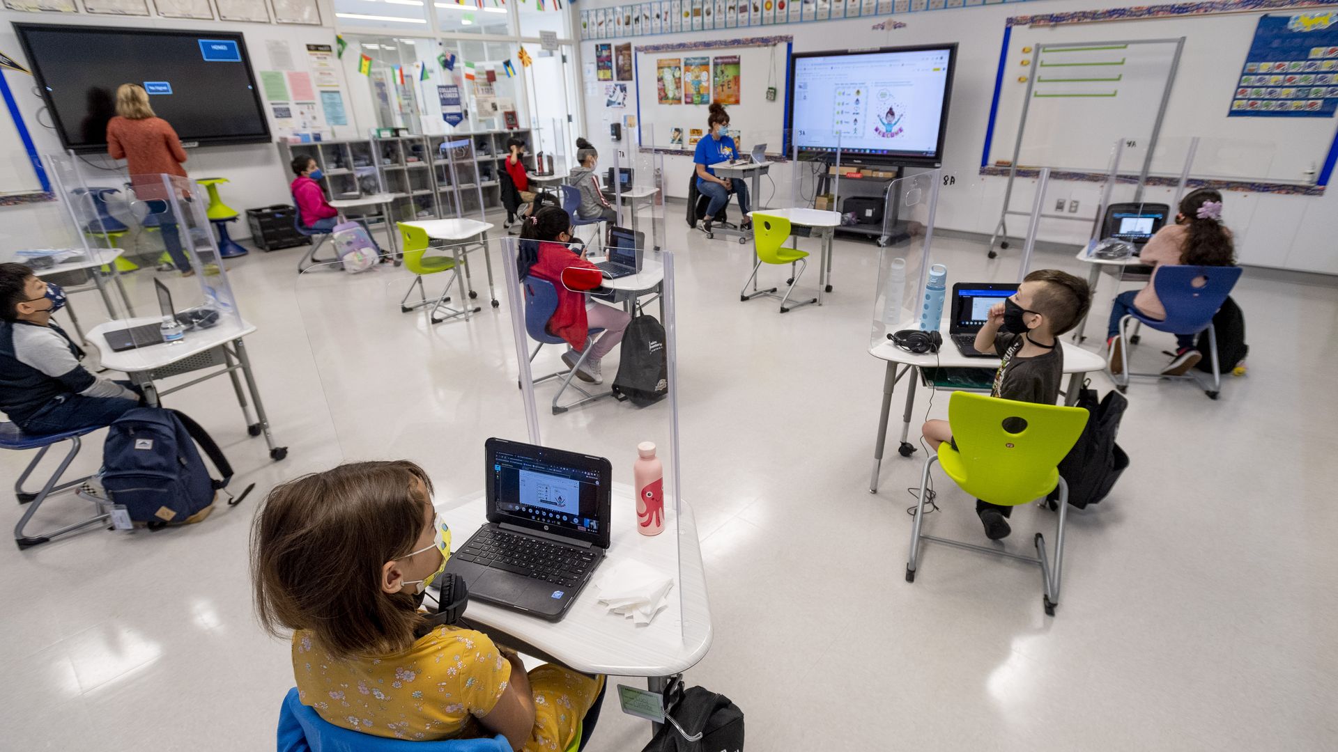 Kids at Sunkist Elementary School in Anaheim, CA wear masks and physically distance while in class.