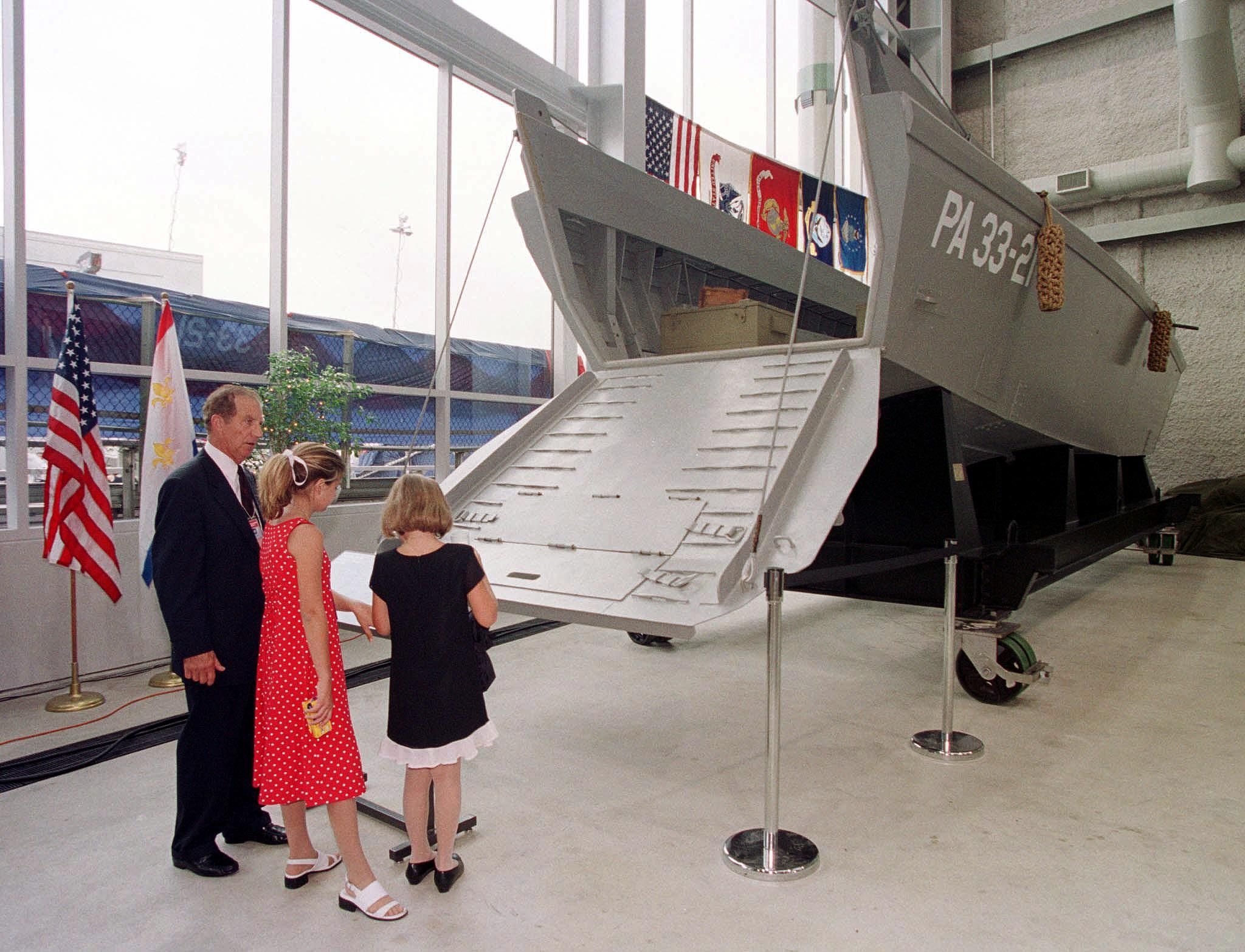 Image shows a family looking at a Higgins boat in the WWII Museum.