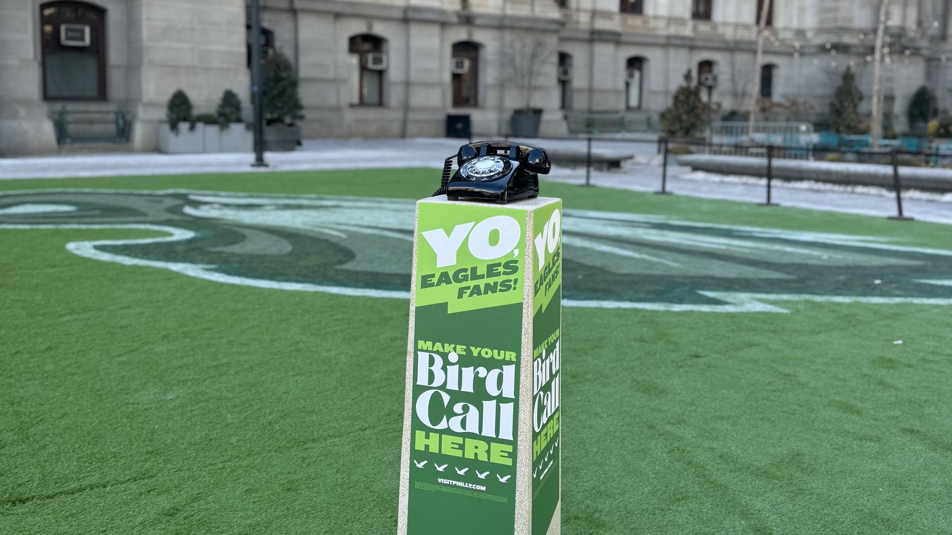 A rotary phone on a pedestal that says "Yo, Eagles fans! Make Your Bird Call Here"