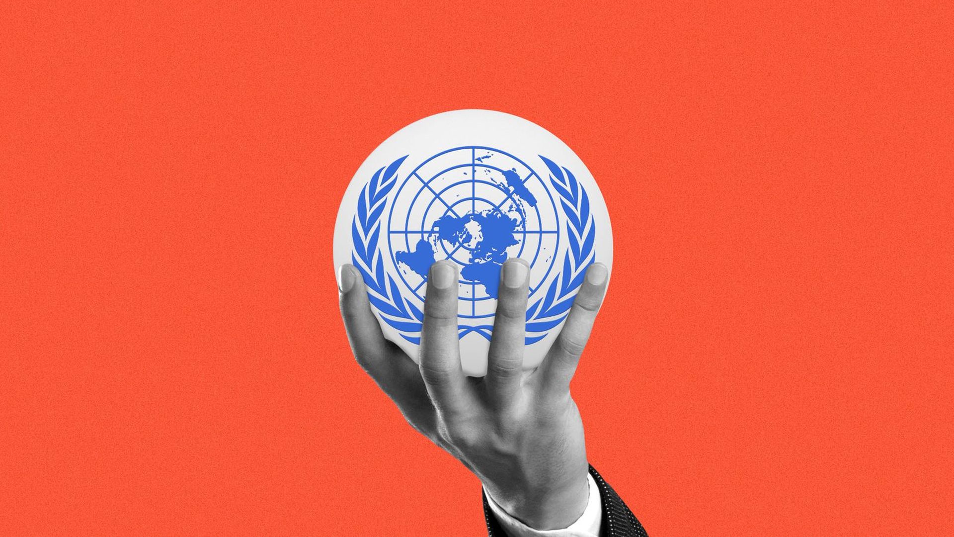 A hand holding the UN symbol