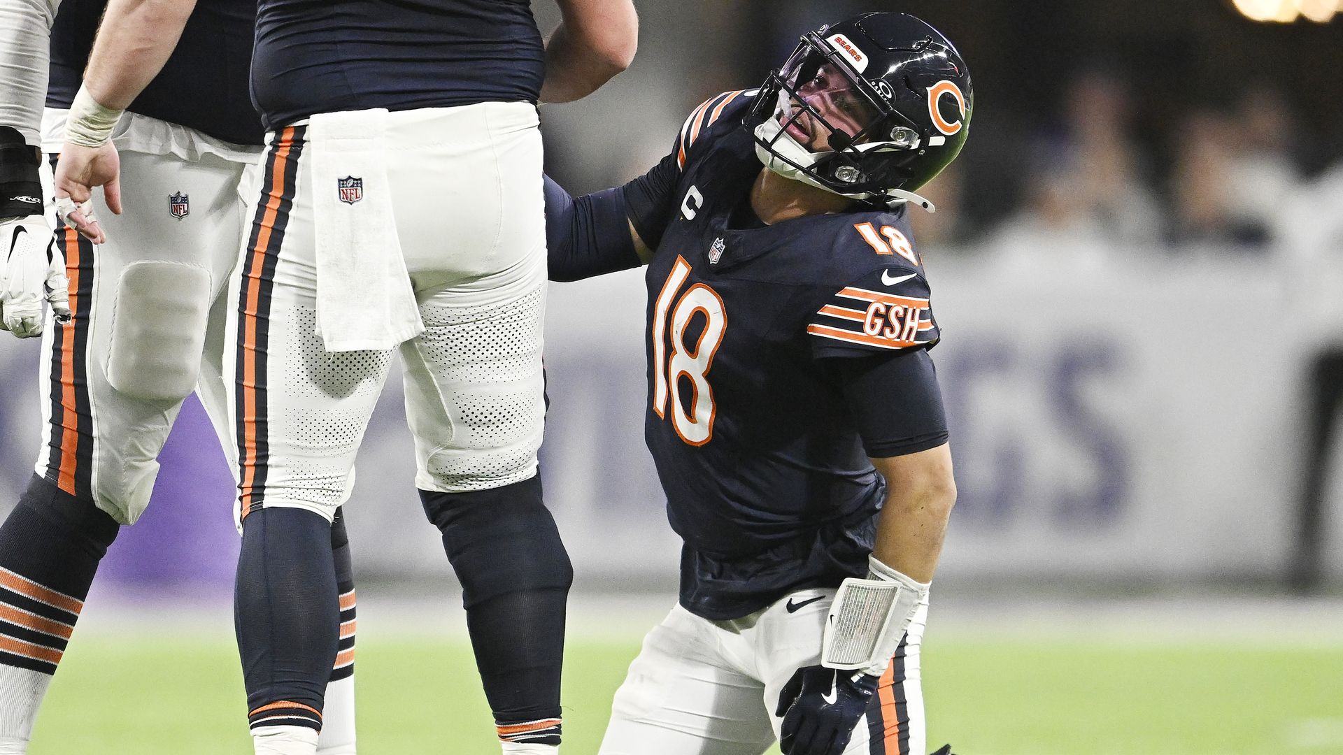 Photo of a football player on his knees after a play on the field 