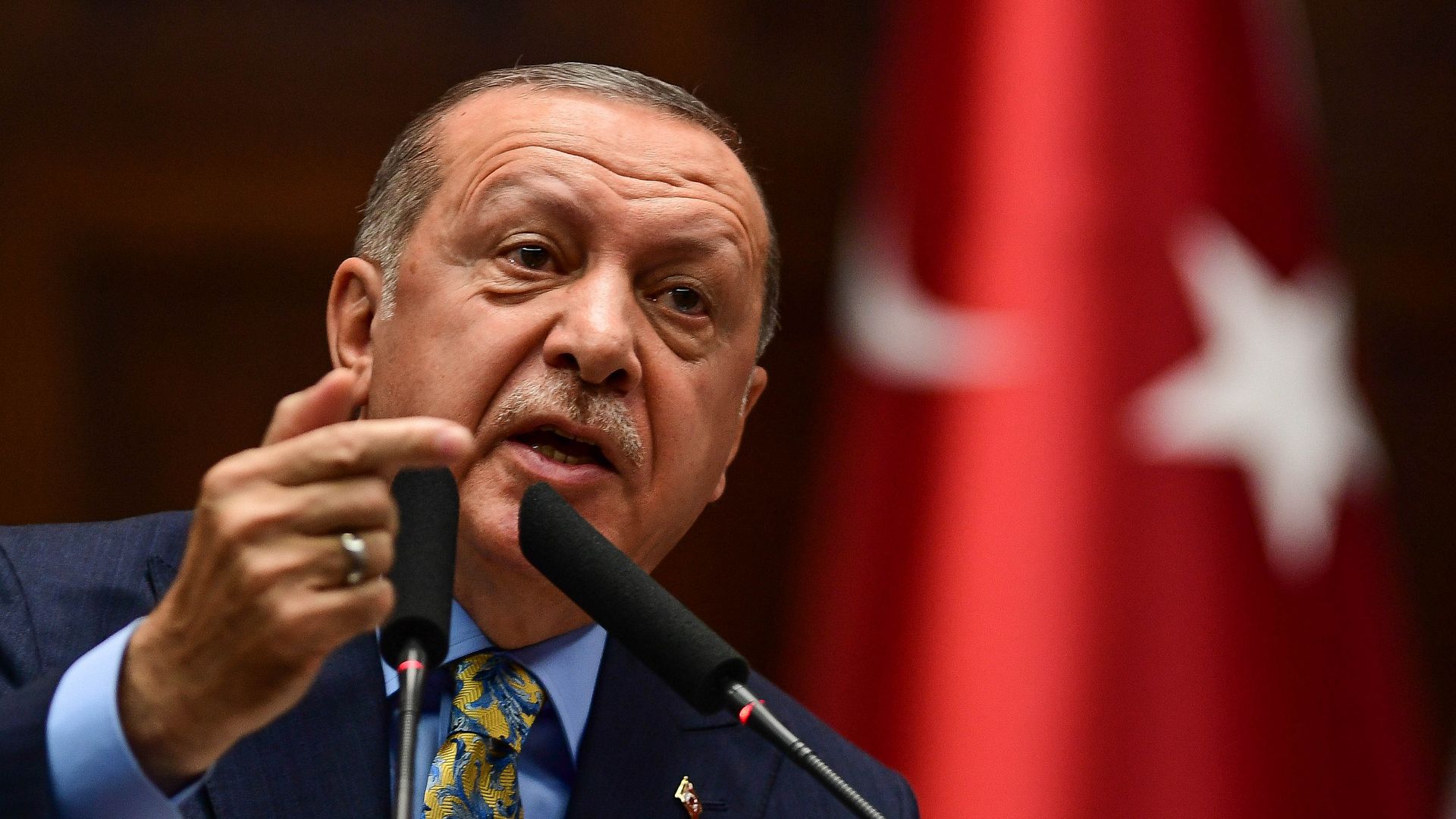 Turkish president erdogan speaking at a podium. 