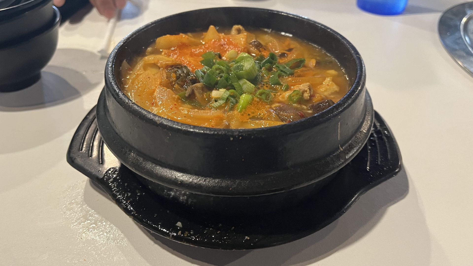Kimchi stew in a black bowl