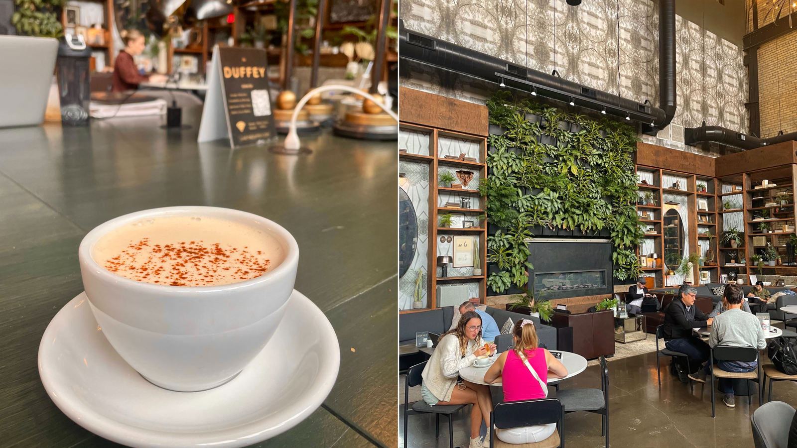 A photo of a latte on a table and a plant-covered wall inside a coffee shop.
