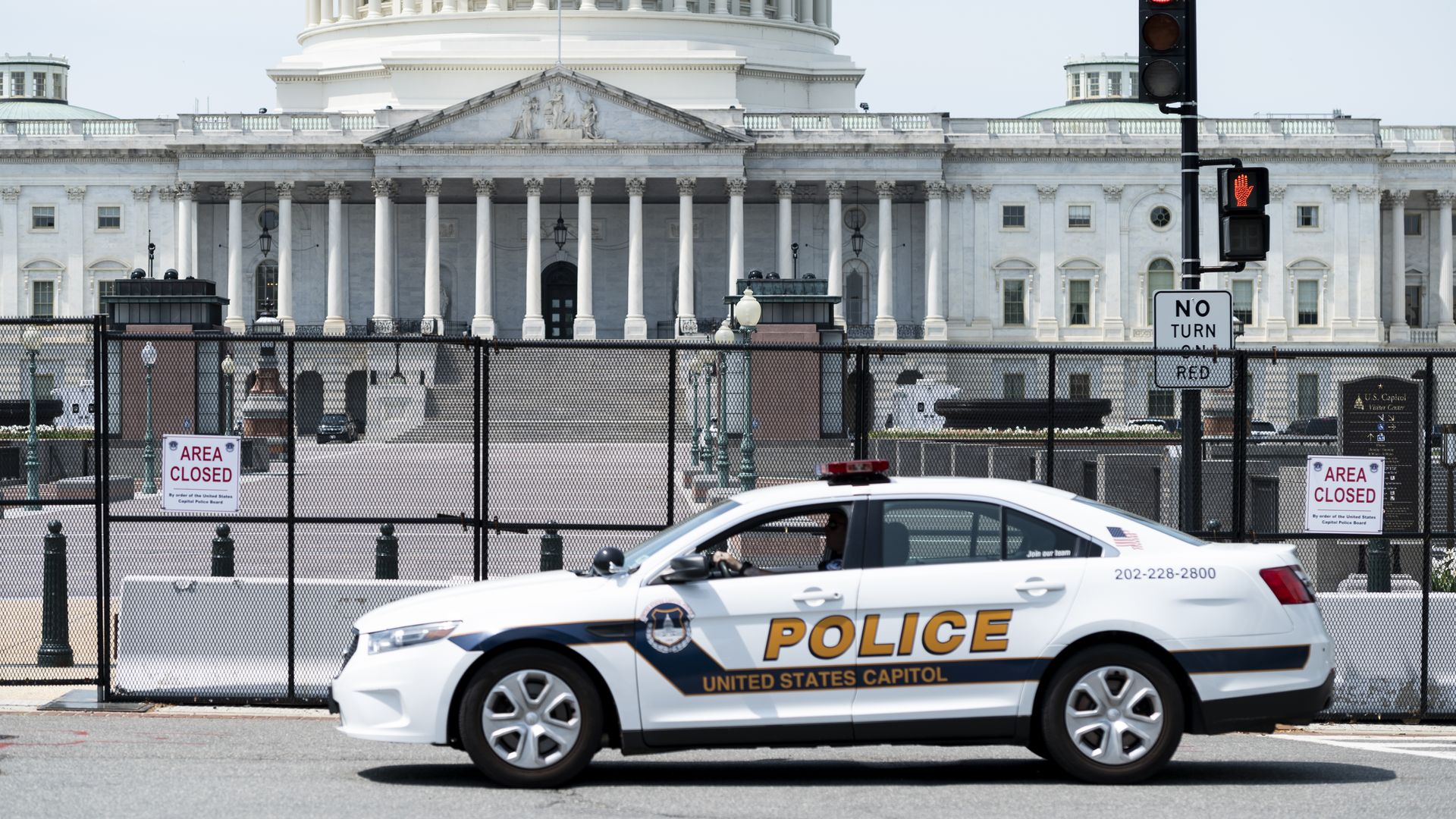 A Capitol police car sits in front of the Capitol building