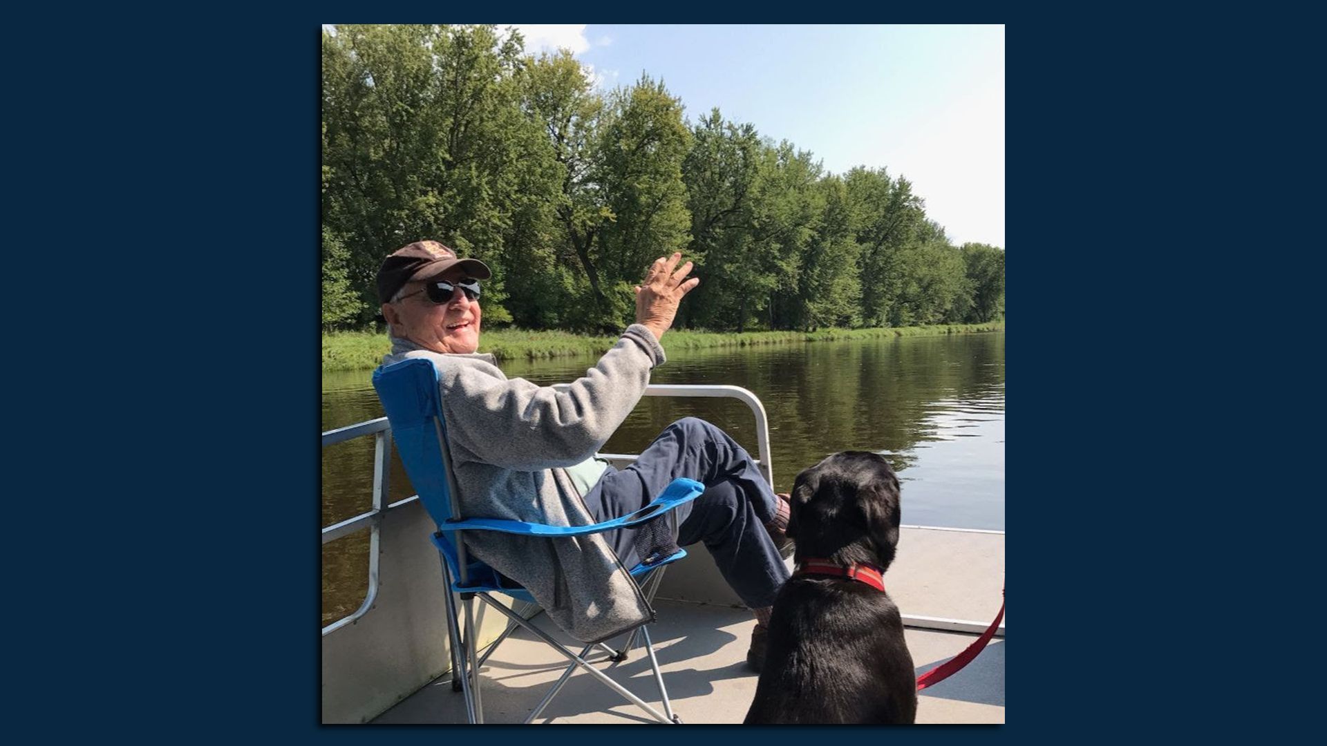 Walter Mondale sits on a pier with his dog overlooking a lake in this picture