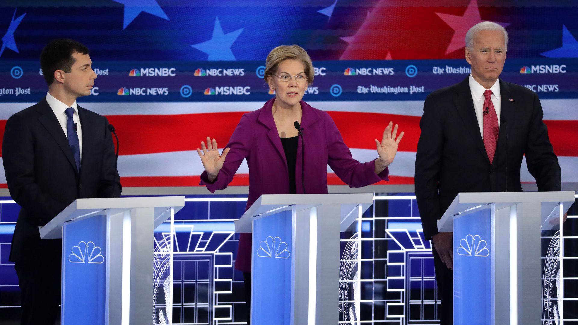 en. Elizabeth Warren (D-MA) (C) speaks as South Bend, Indiana Mayor Pete Buttigieg (L) and former Vice President Joe Biden (R) listen during the Democratic  Debate November 20 in Atlanta