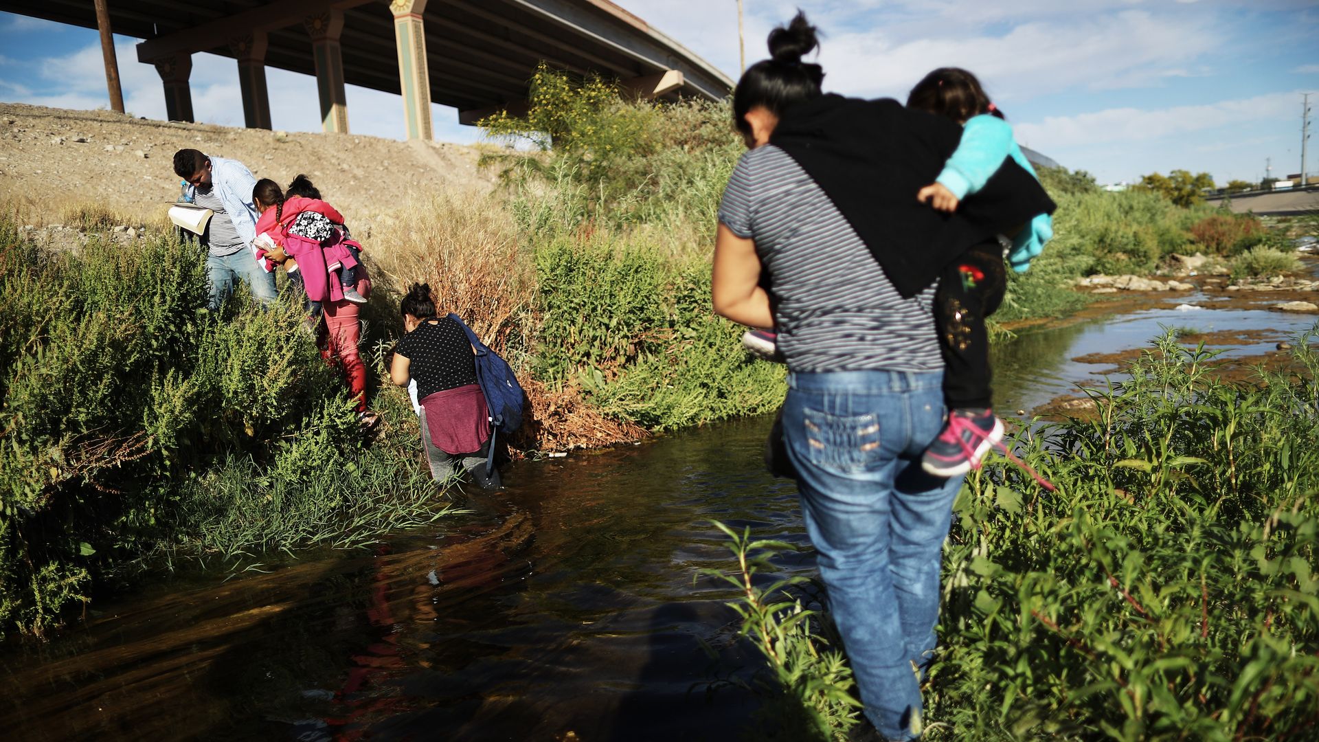 Migrants cross the border between the U.S. and Mexico at the Rio Grande river, as they walk to enter El Paso, Texas,.