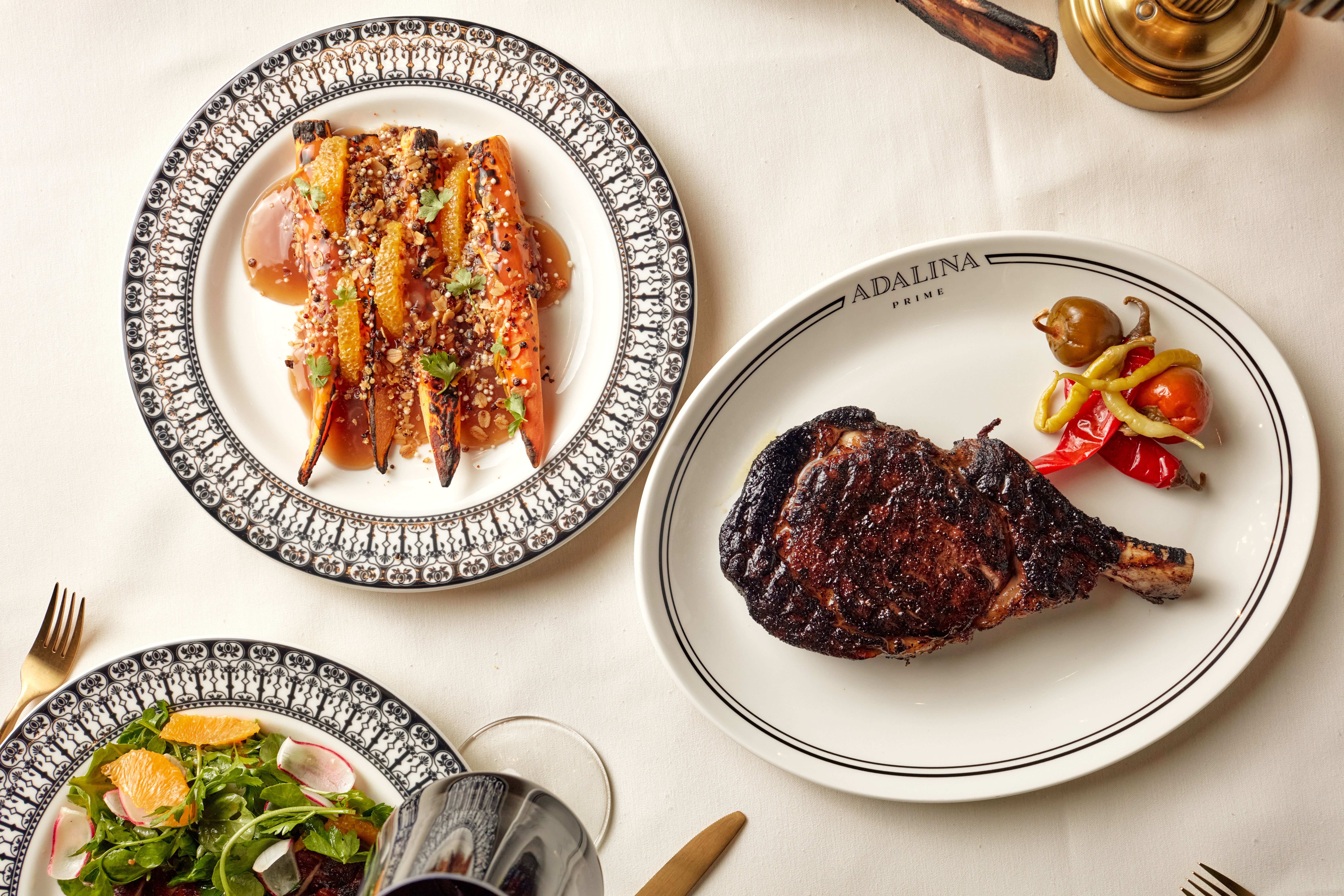 steak and carrots on a table 