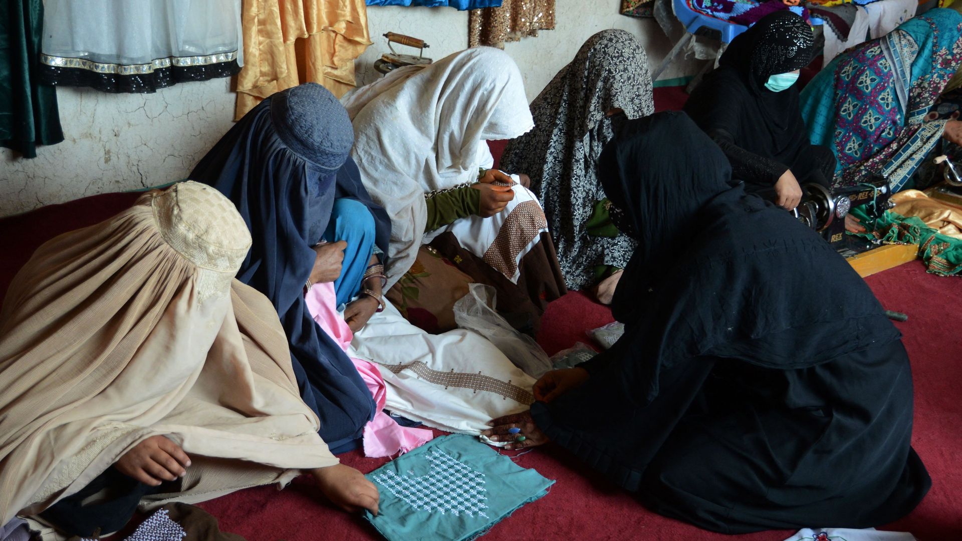 Women stich garments at the workshop of a women run company in Kandahar on May 21